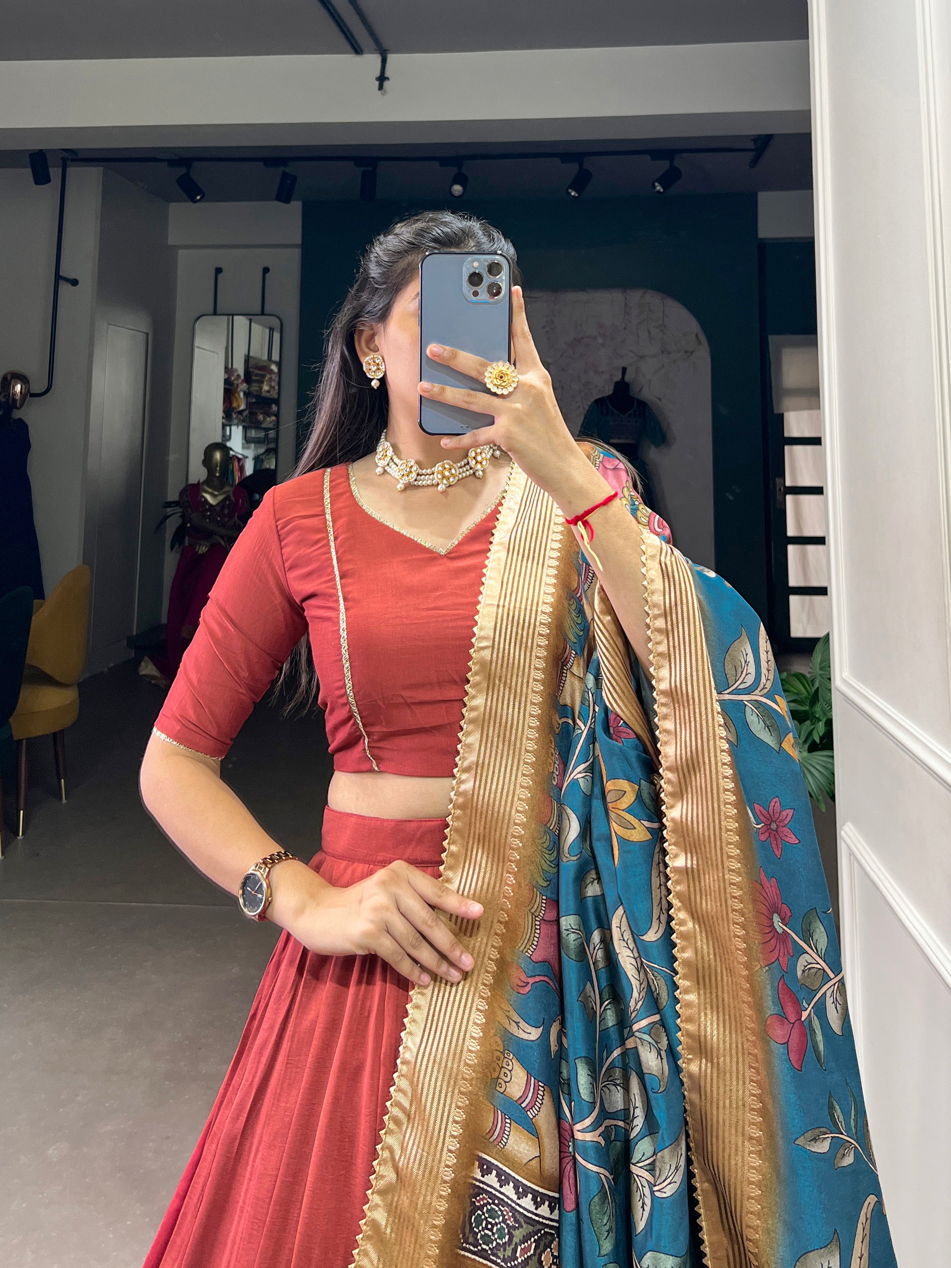 Rust Red Silk Lehenga with Golden Border and Contrasting Blue Floral Dupatta