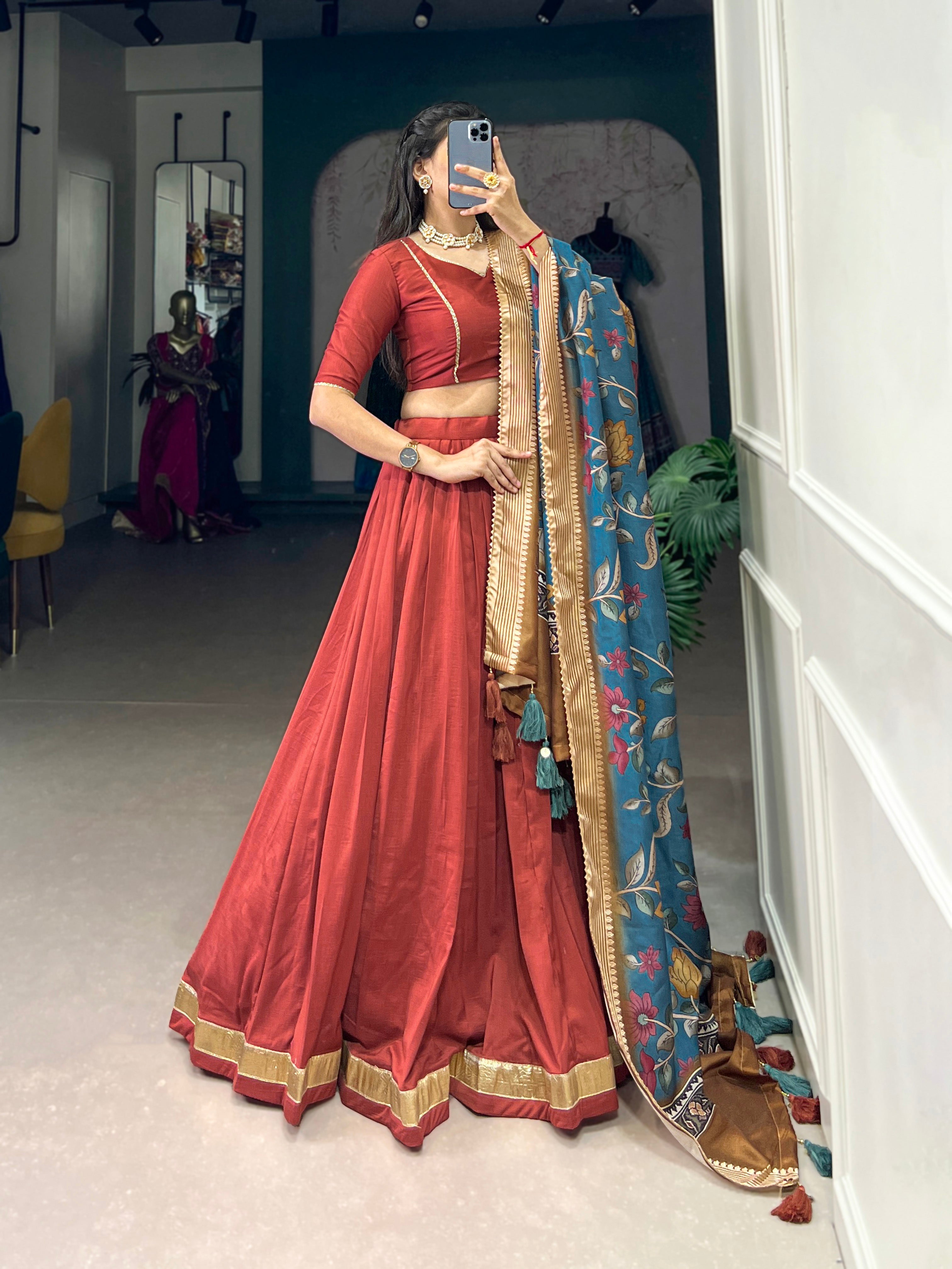 Rust Red Silk Lehenga with Golden Border and Contrasting Blue Floral Dupatta