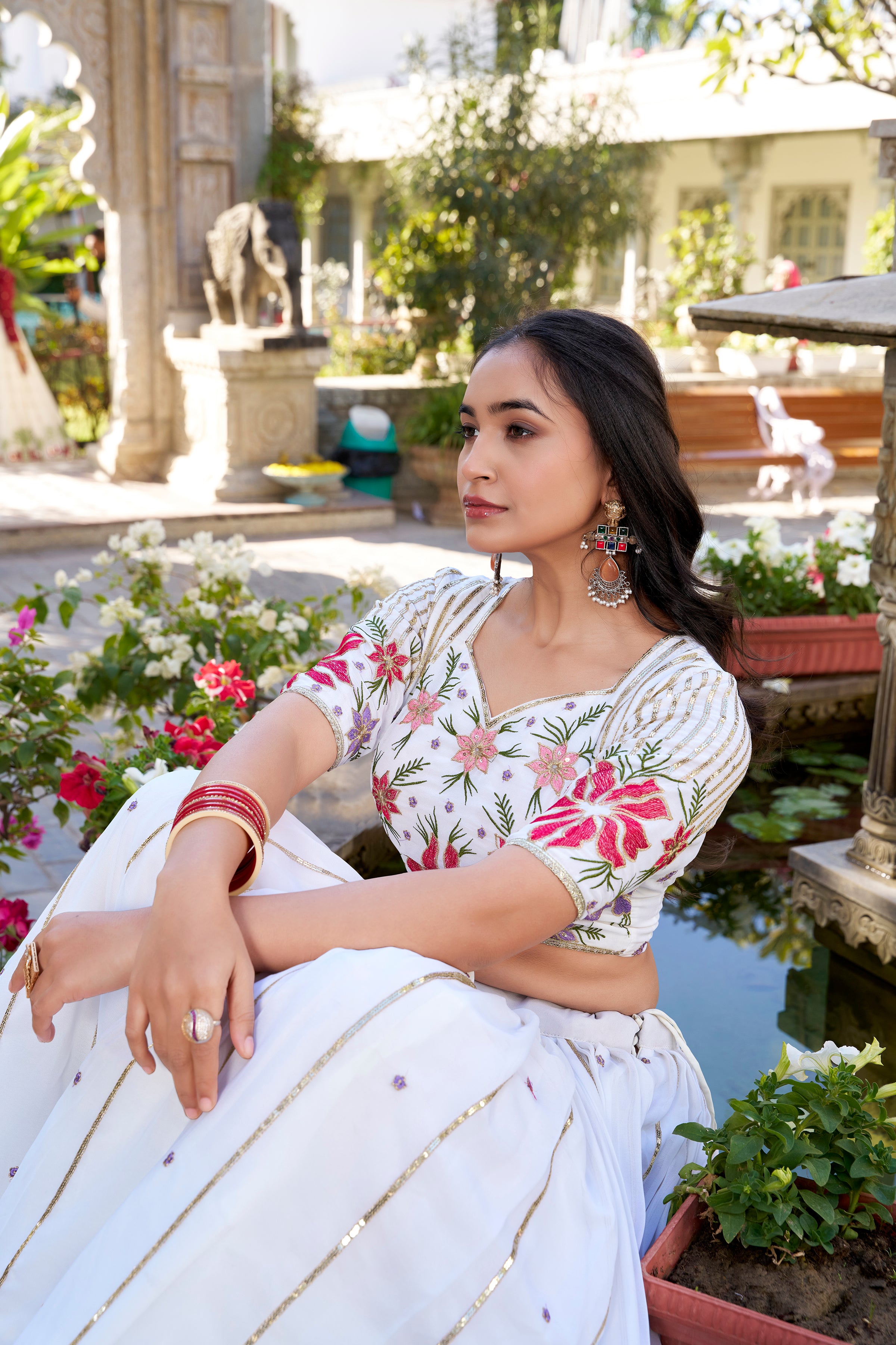 Serene White Lehenga with a Vibrant Floral Garden Print and Gold Border