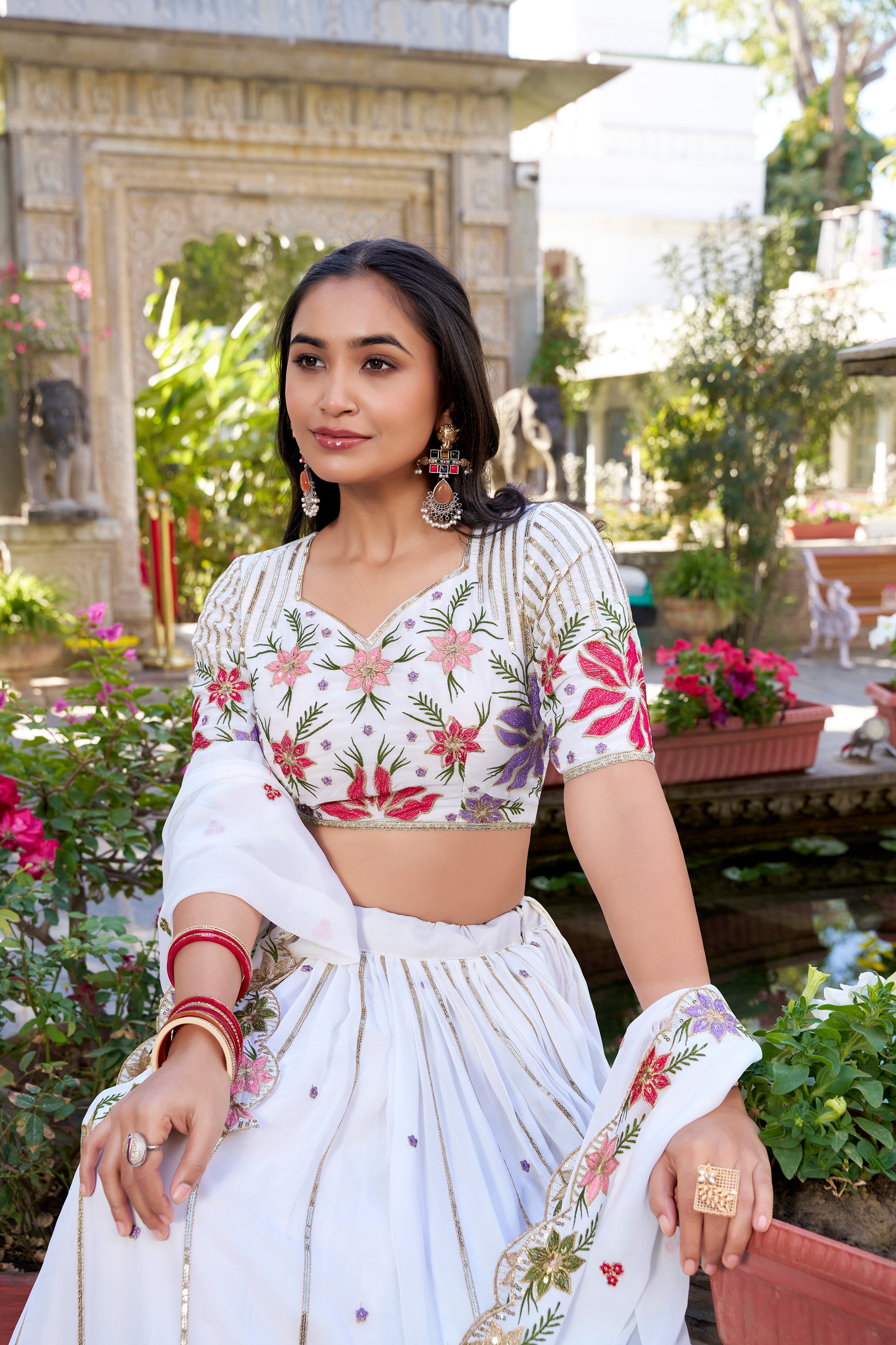 Serene White Lehenga with a Vibrant Floral Garden Print and Gold Border