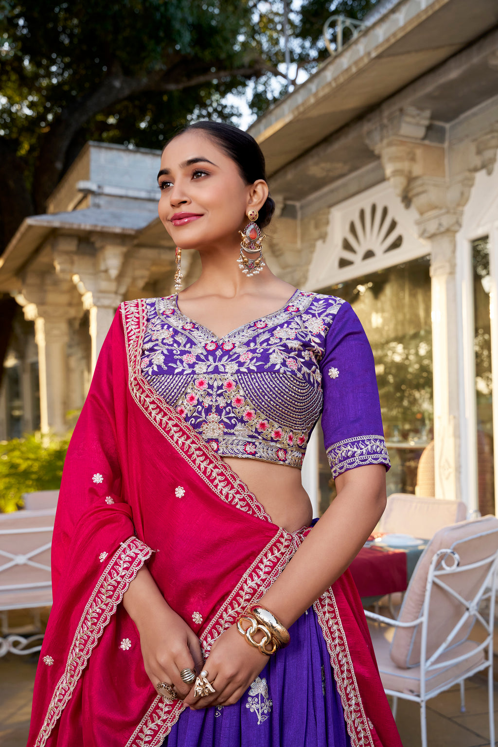A vision of regal elegance in a vibrant purple and magenta lehenga.