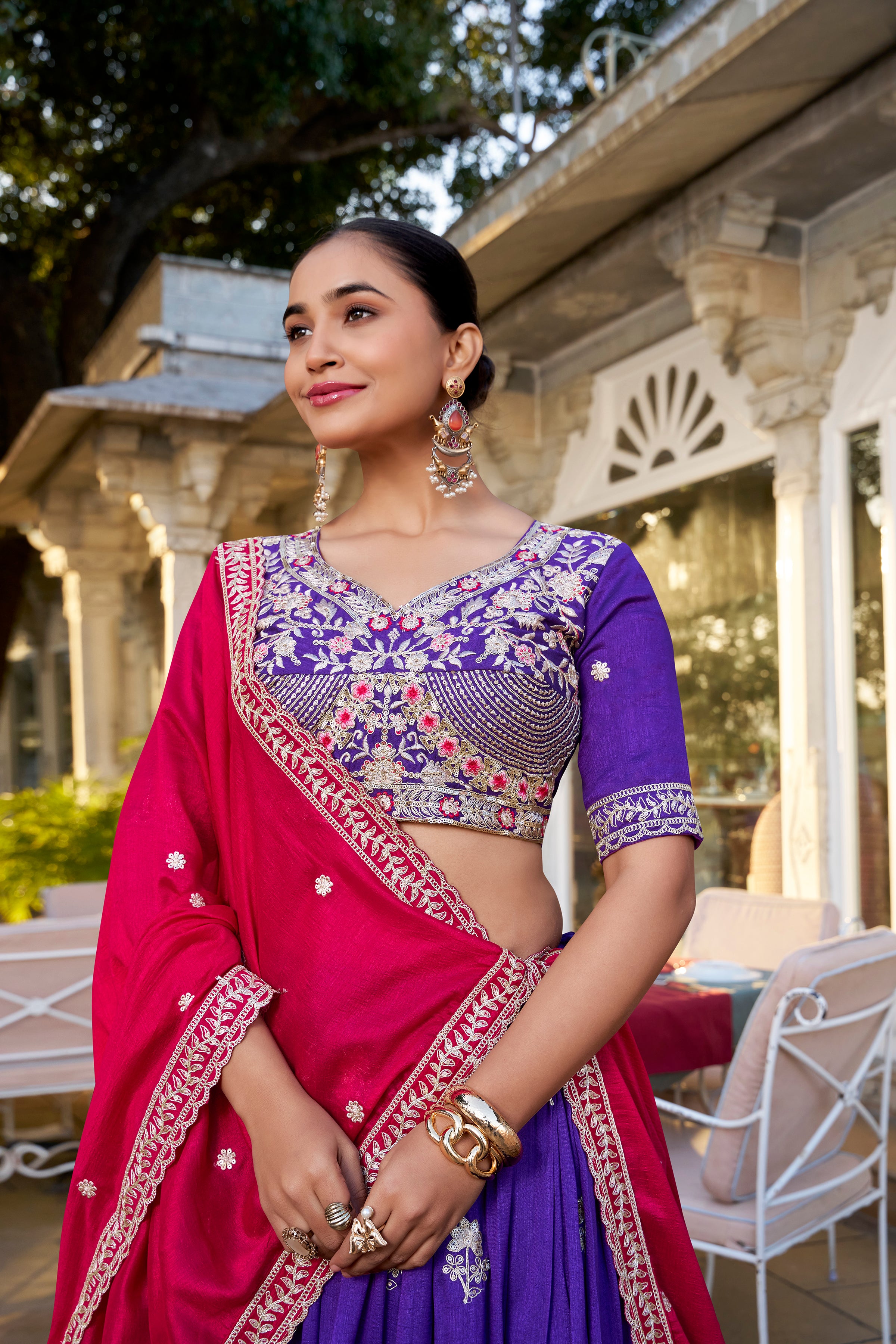 A vision of regal elegance in a vibrant purple and magenta lehenga.