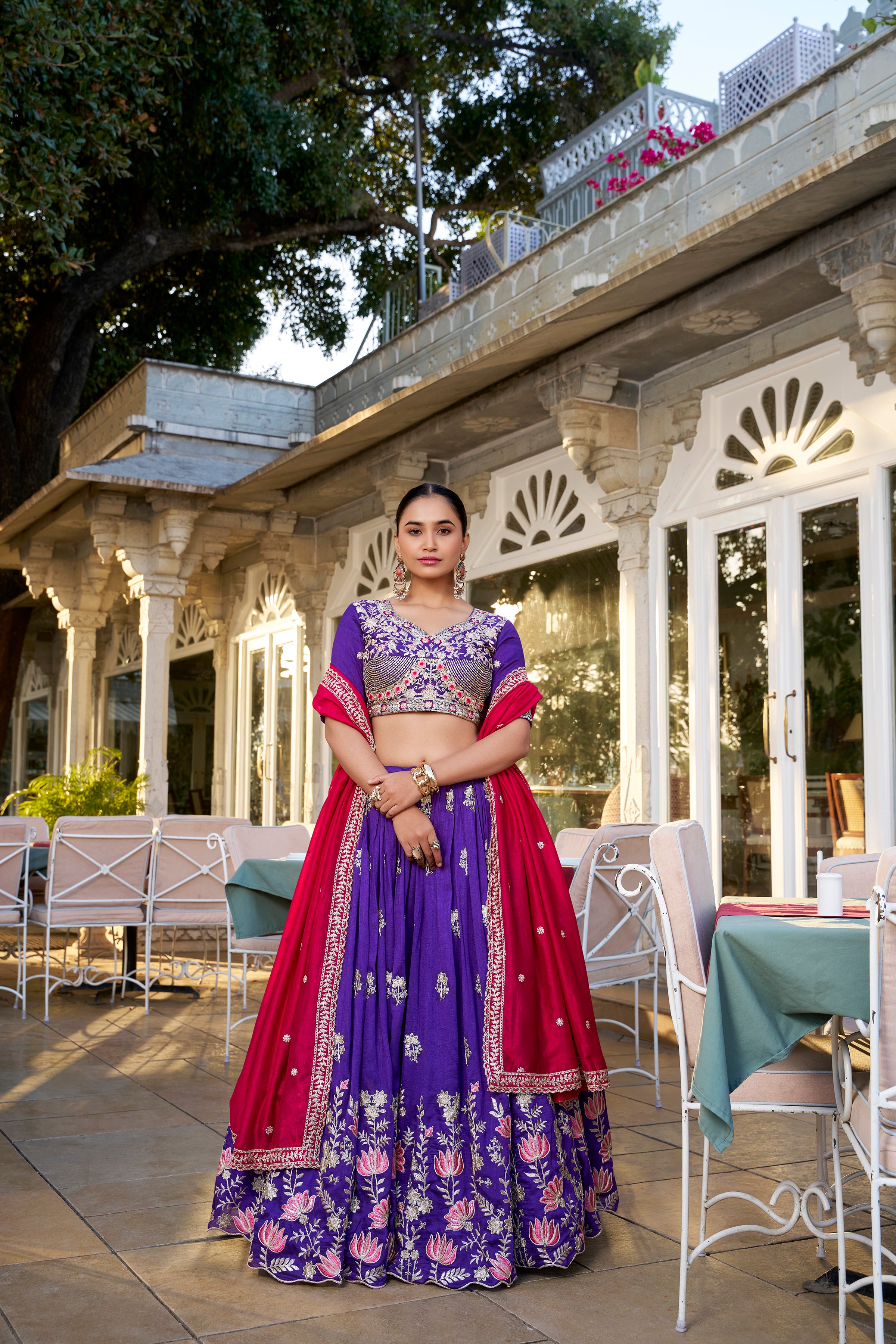A vision of regal elegance in a vibrant purple and magenta lehenga.