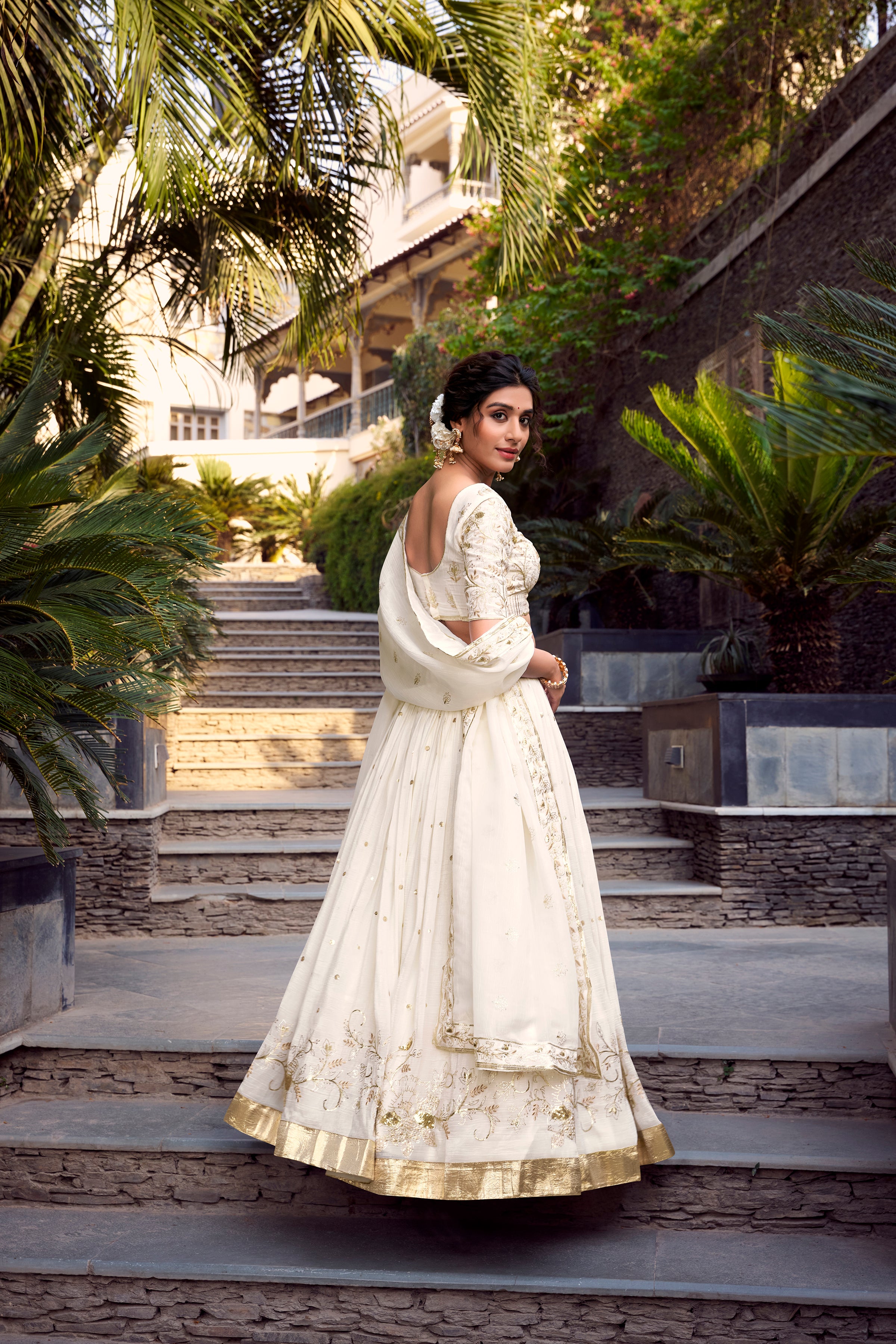 Graceful Off-White Lehenga Choli featuring Delicate Gold Floral Embroidery and a Broad Zari Border