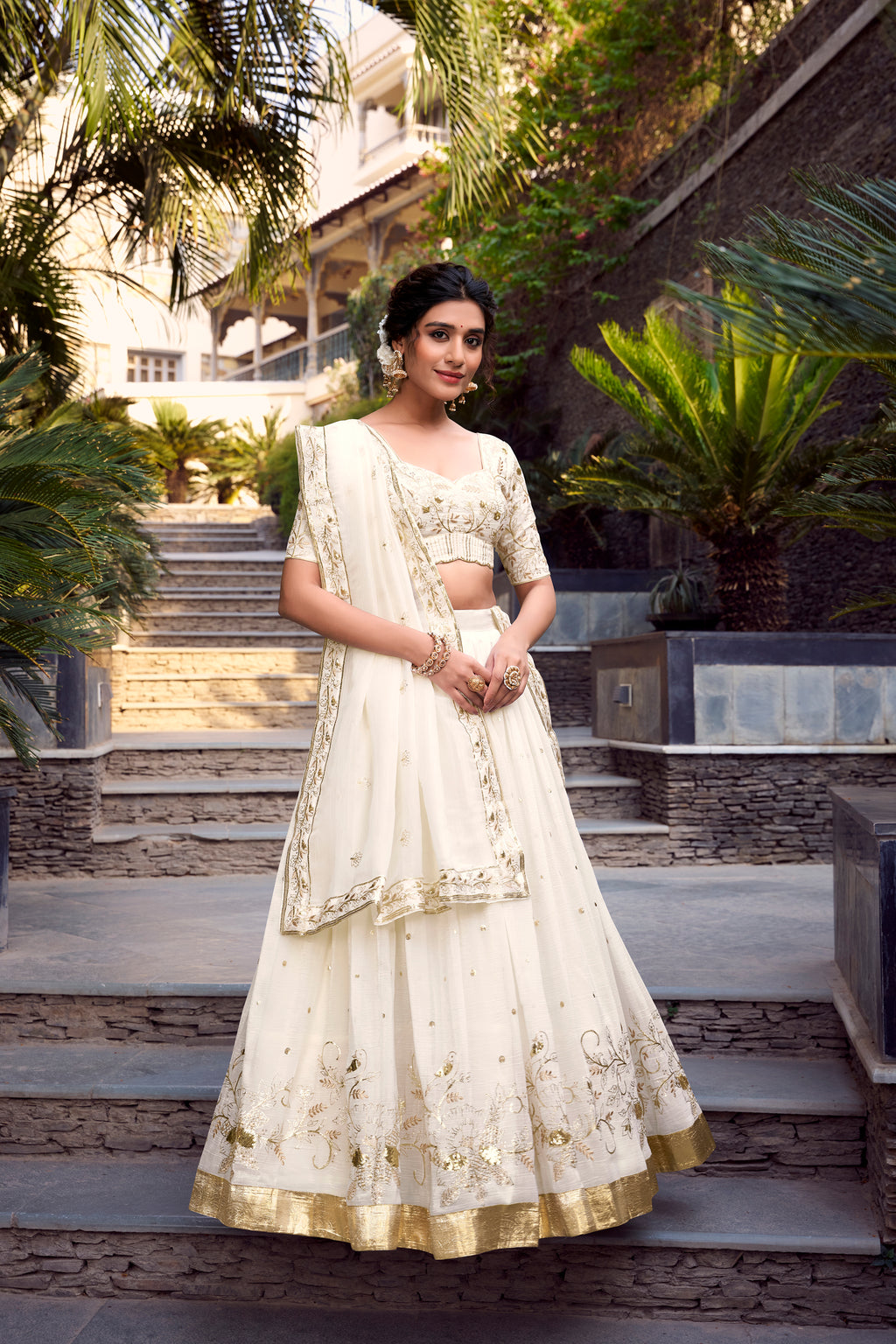 Graceful Off-White Lehenga Choli featuring Delicate Gold Floral Embroidery and a Broad Zari Border