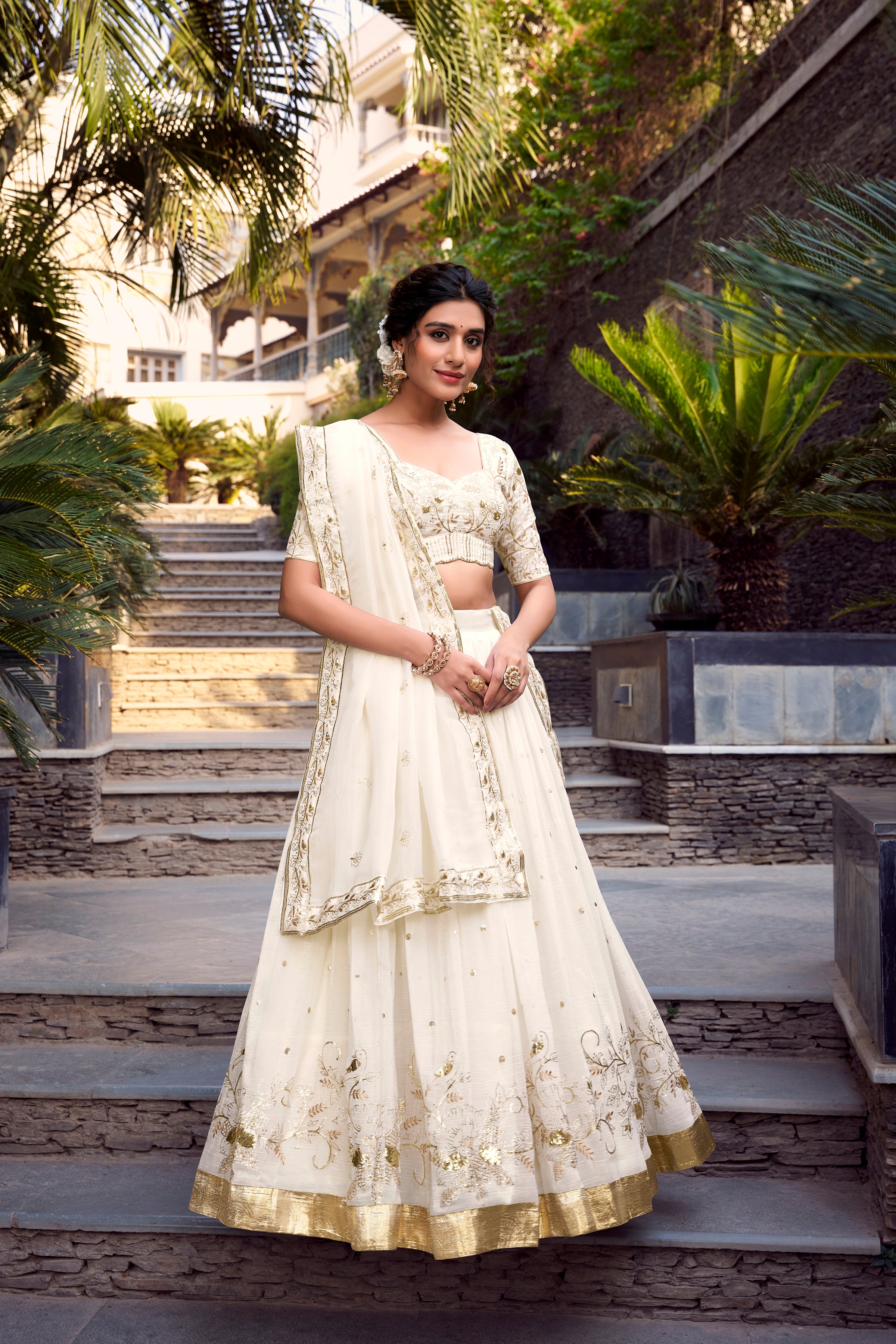 Graceful Off-White Lehenga Choli featuring Delicate Gold Floral Embroidery and a Broad Zari Border