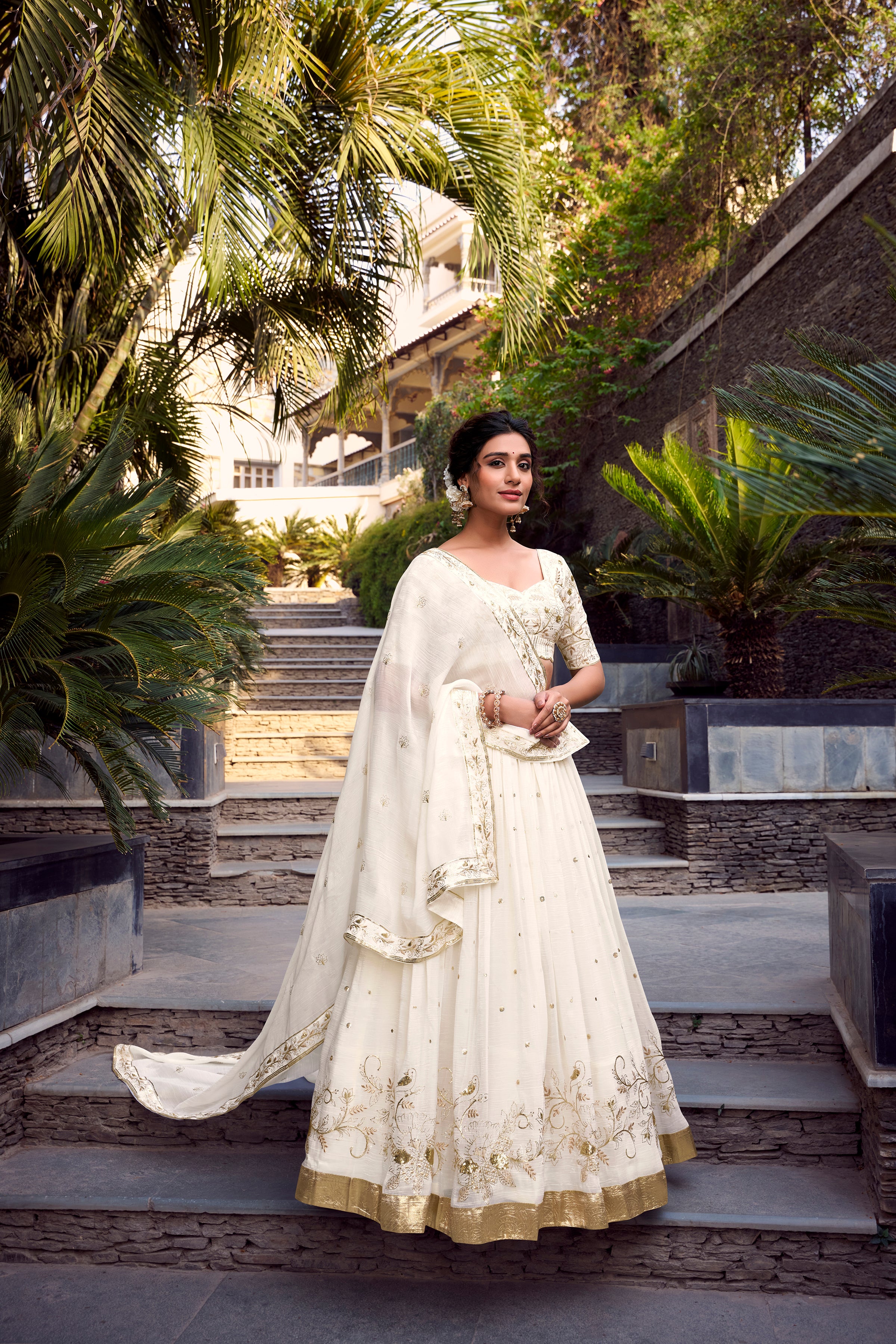 Graceful Off-White Lehenga Choli featuring Delicate Gold Floral Embroidery and a Broad Zari Border