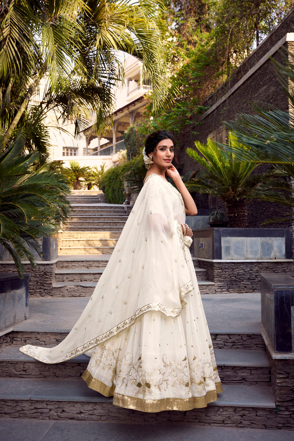 Graceful Off-White Lehenga Choli featuring Delicate Gold Floral Embroidery and a Broad Zari Border