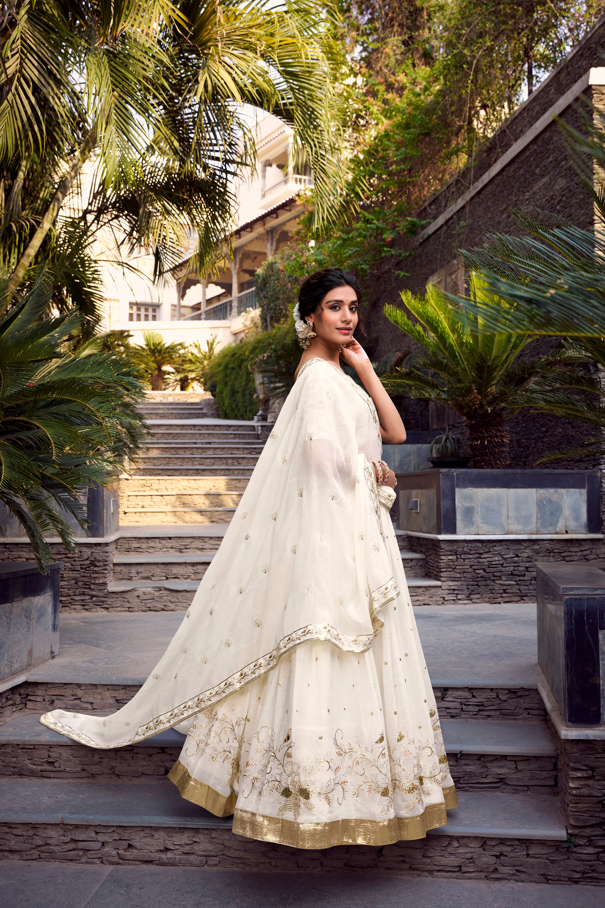 Graceful Off-White Lehenga Choli featuring Delicate Gold Floral Embroidery and a Broad Zari Border