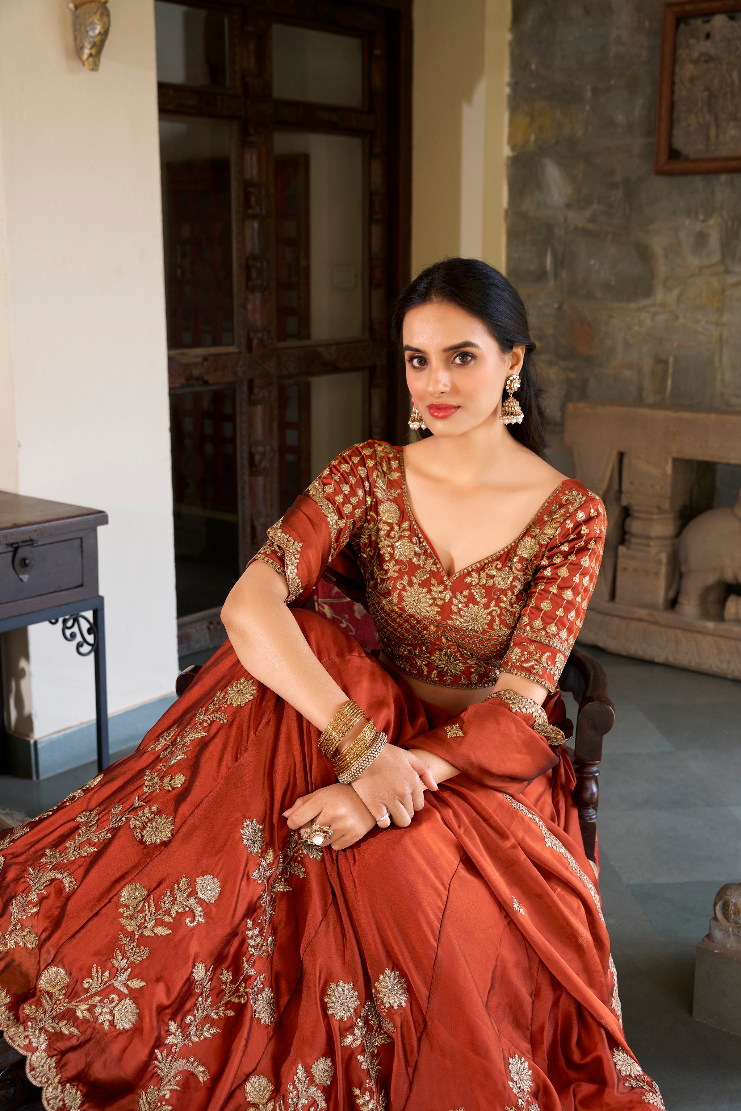 A vision of timeless elegance in a radiant rust-orange lehenga.