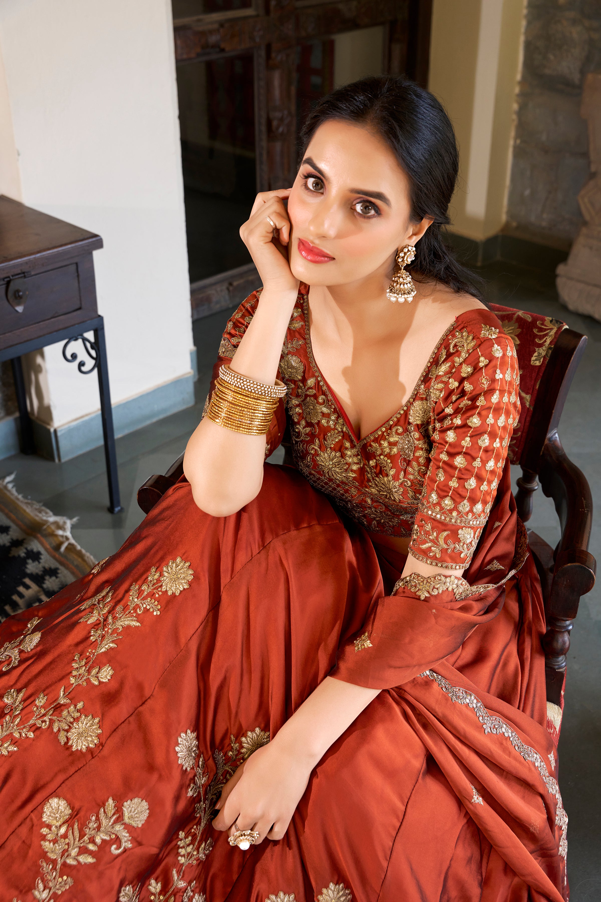 A vision of timeless elegance in a radiant rust-orange lehenga.
