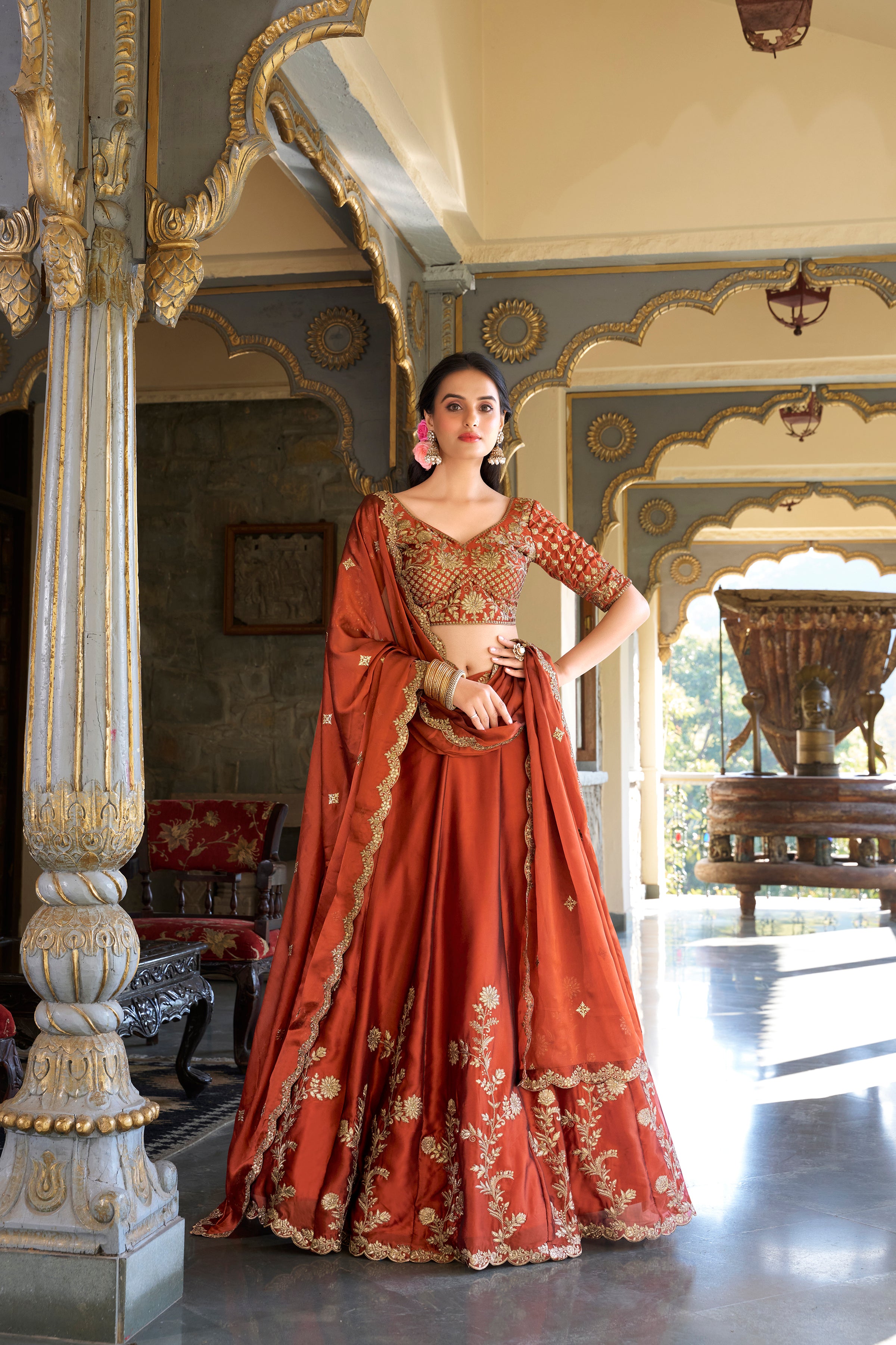 A vision of timeless elegance in a radiant rust-orange lehenga.
