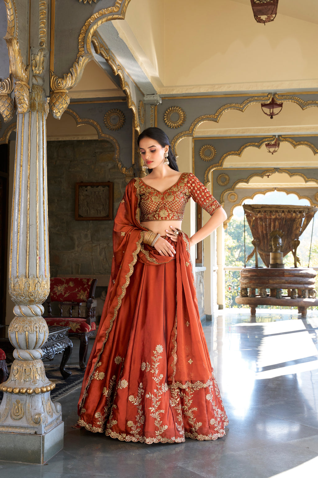 A vision of timeless elegance in a radiant rust-orange lehenga.
