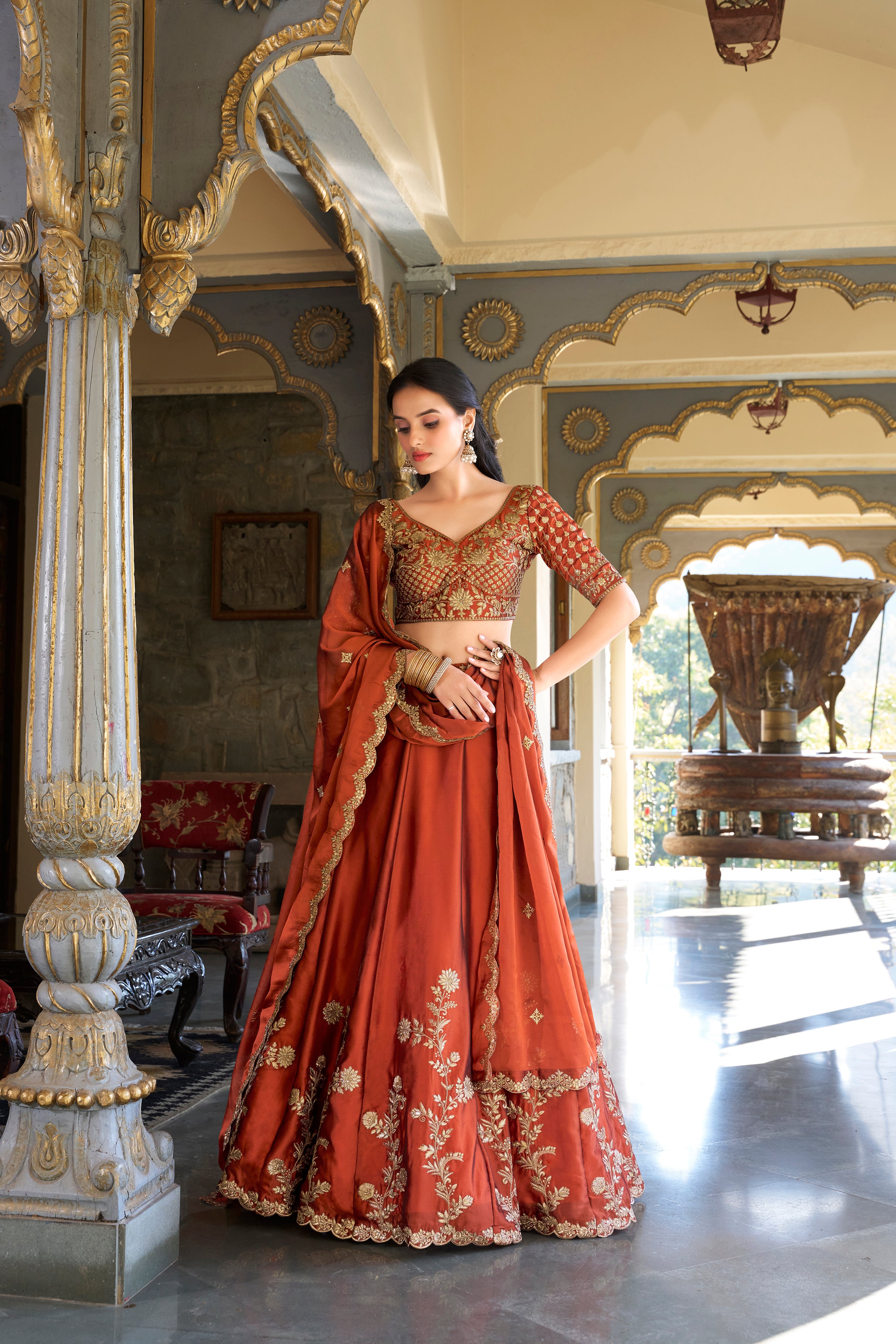 A vision of timeless elegance in a radiant rust-orange lehenga.