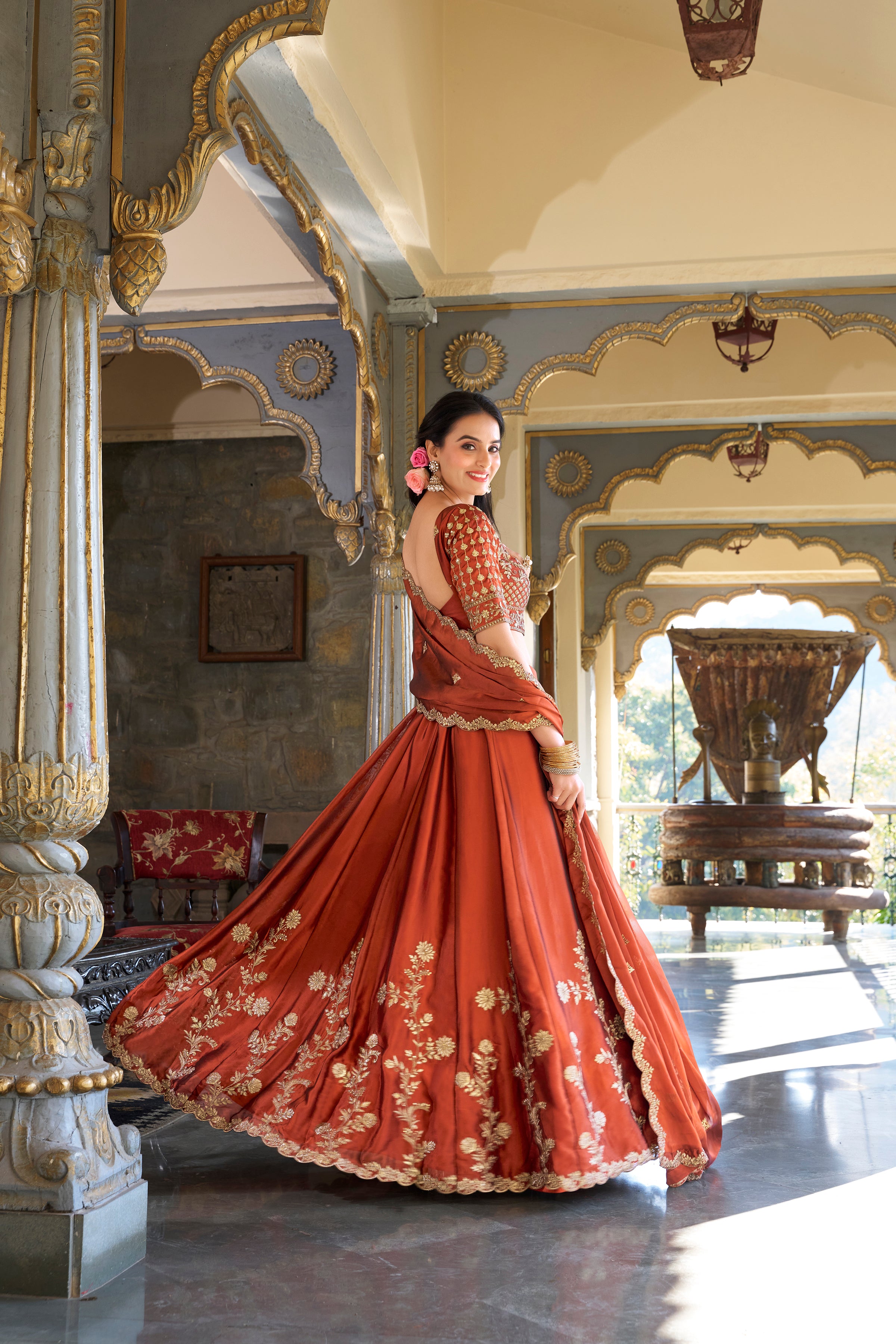 A vision of timeless elegance in a radiant rust-orange lehenga.