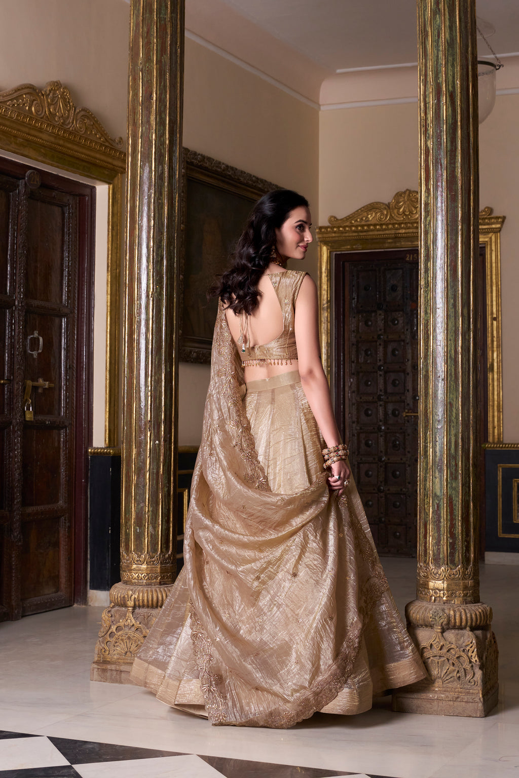 Regal radiance in a shimmering antique gold lehenga.