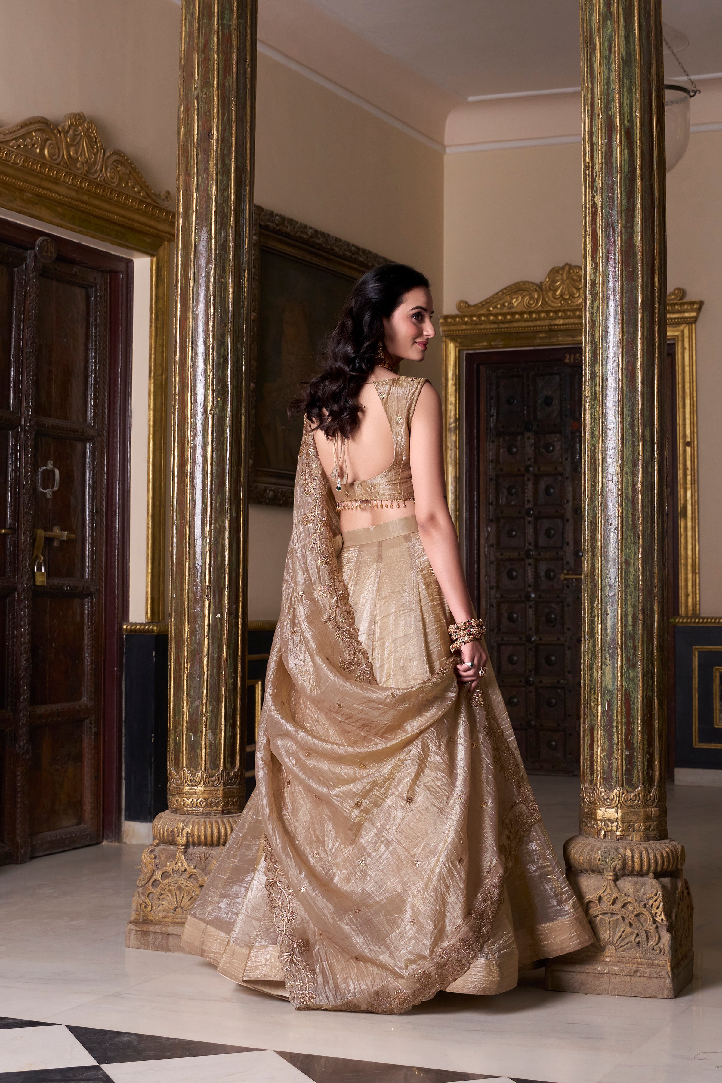 Regal radiance in a shimmering antique gold lehenga.