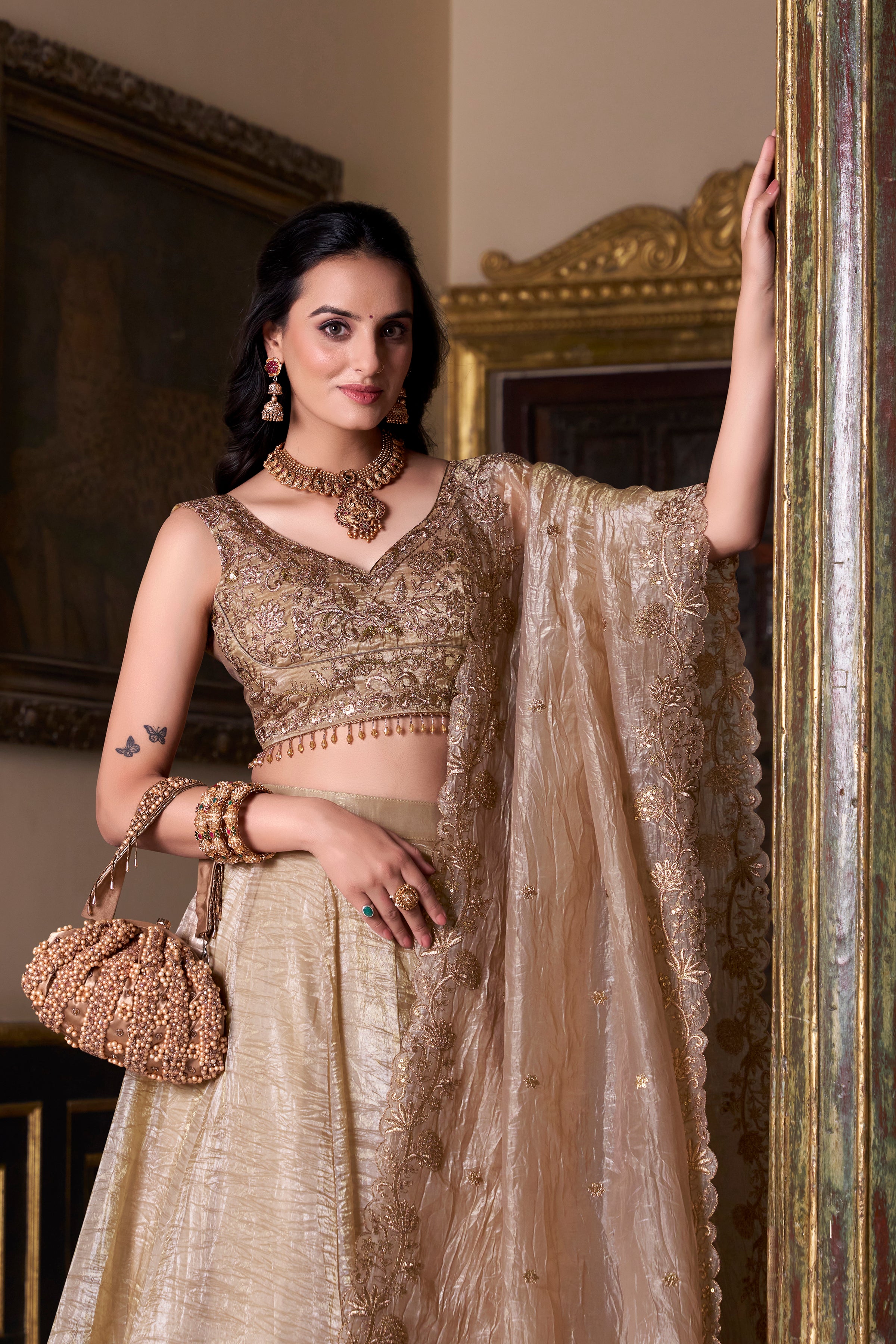 Regal radiance in a shimmering antique gold lehenga.