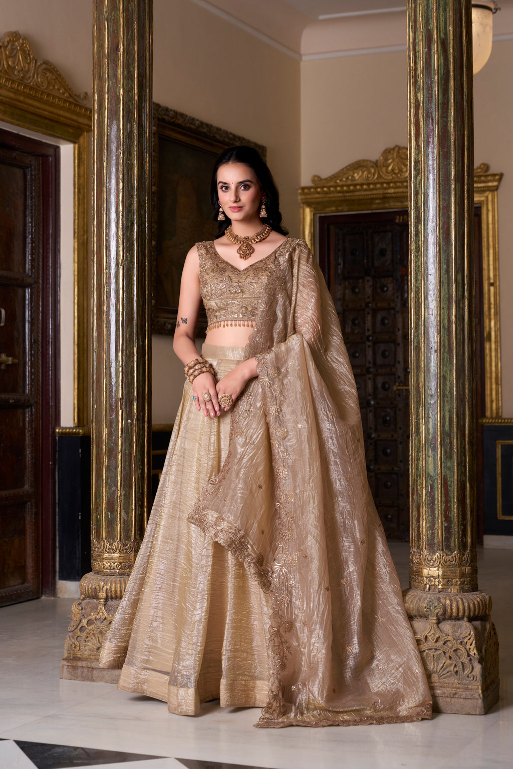 Regal radiance in a shimmering antique gold lehenga.
