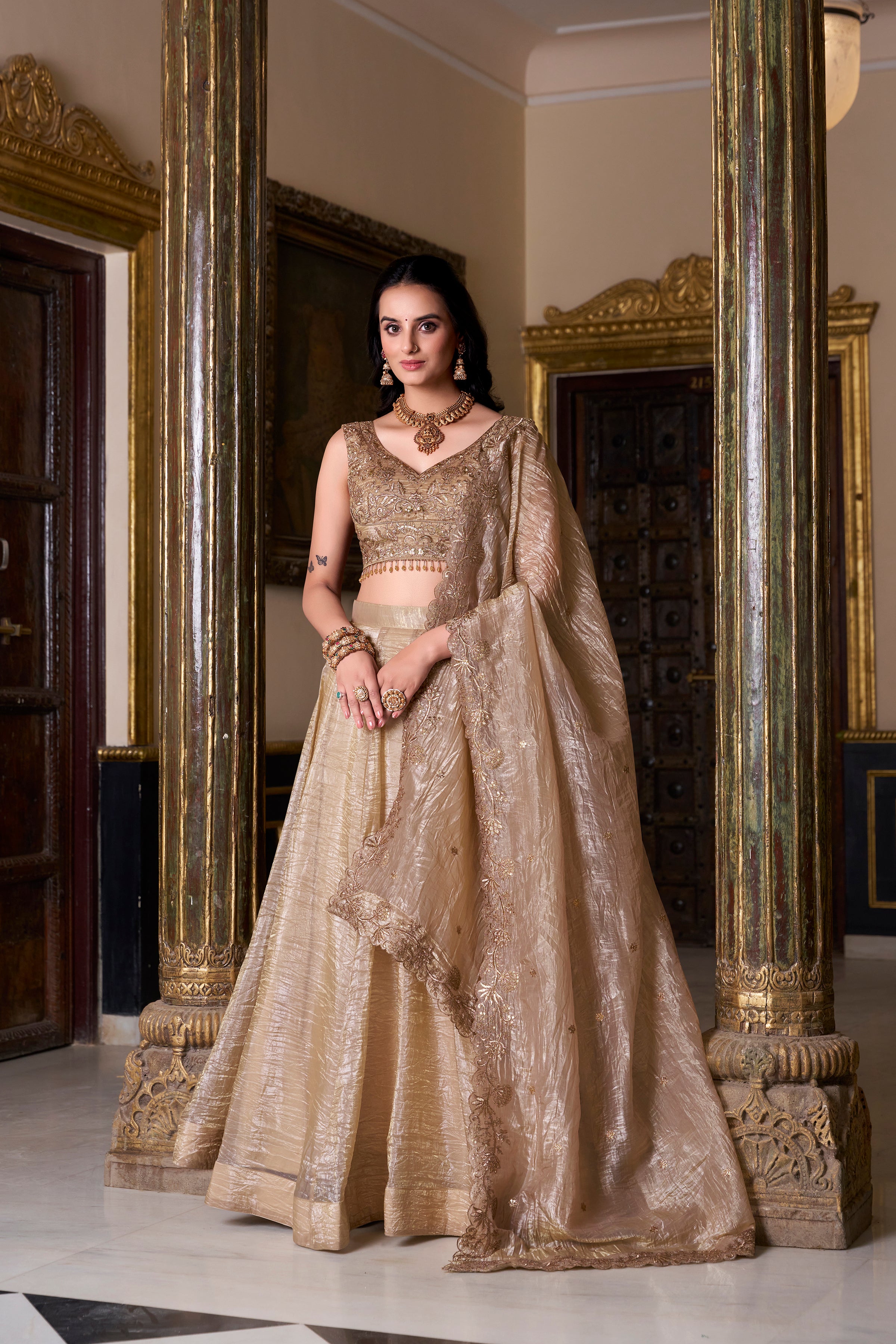 Regal radiance in a shimmering antique gold lehenga.