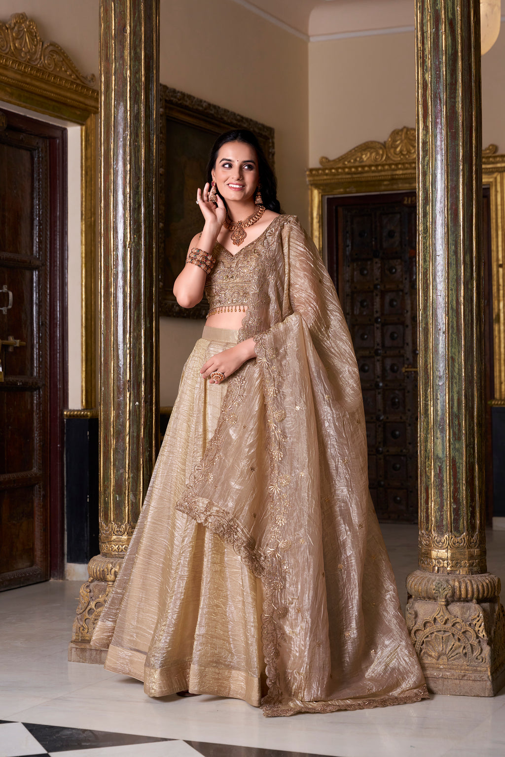 Regal radiance in a shimmering antique gold lehenga.