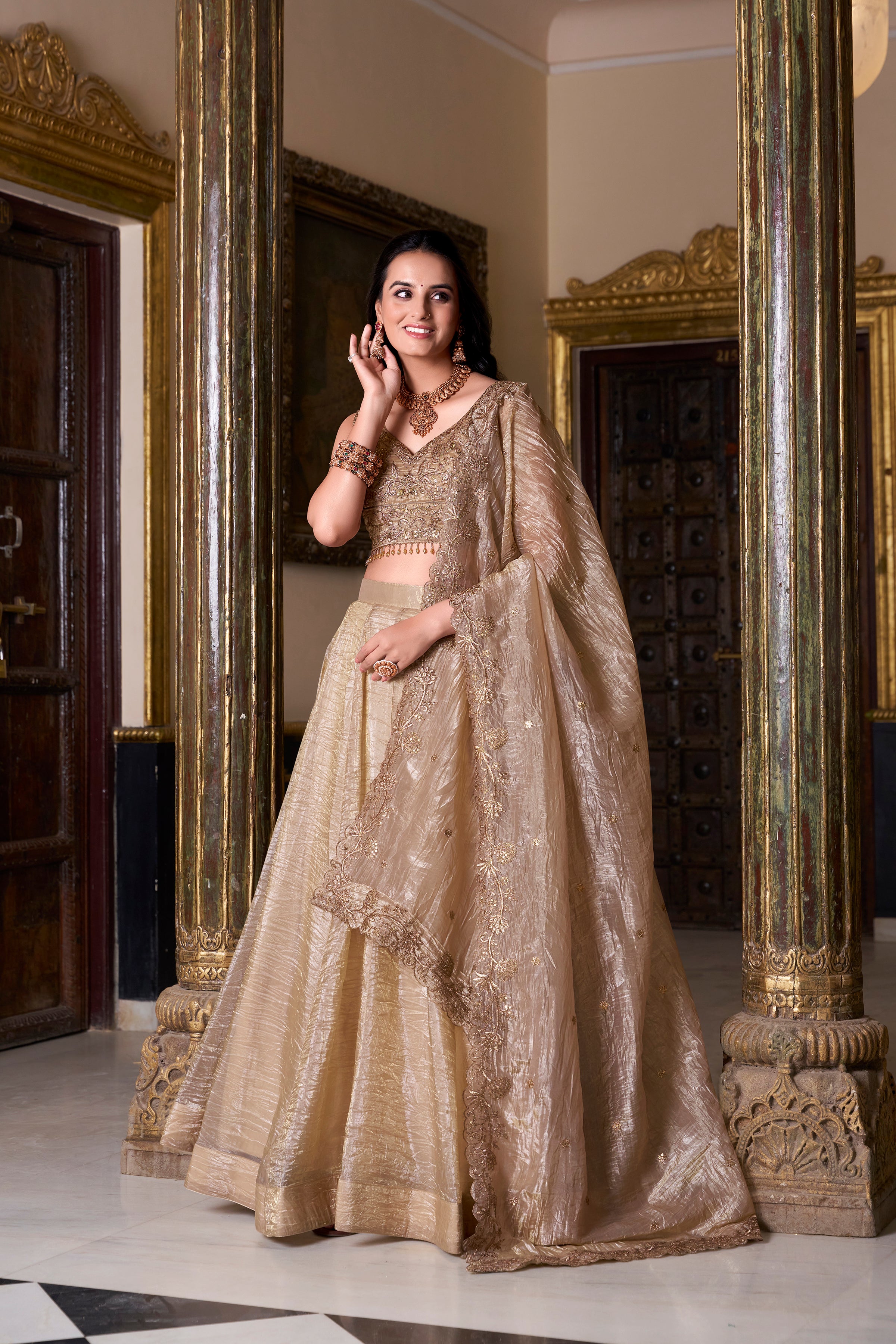 Regal radiance in a shimmering antique gold lehenga.