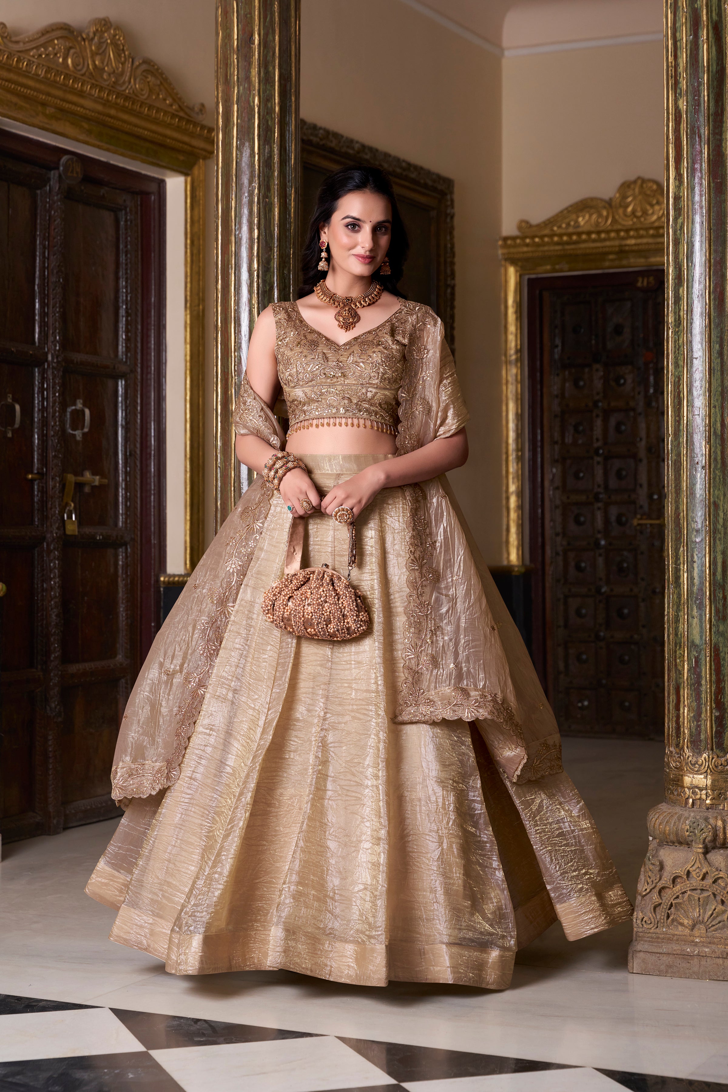 Regal radiance in a shimmering antique gold lehenga.