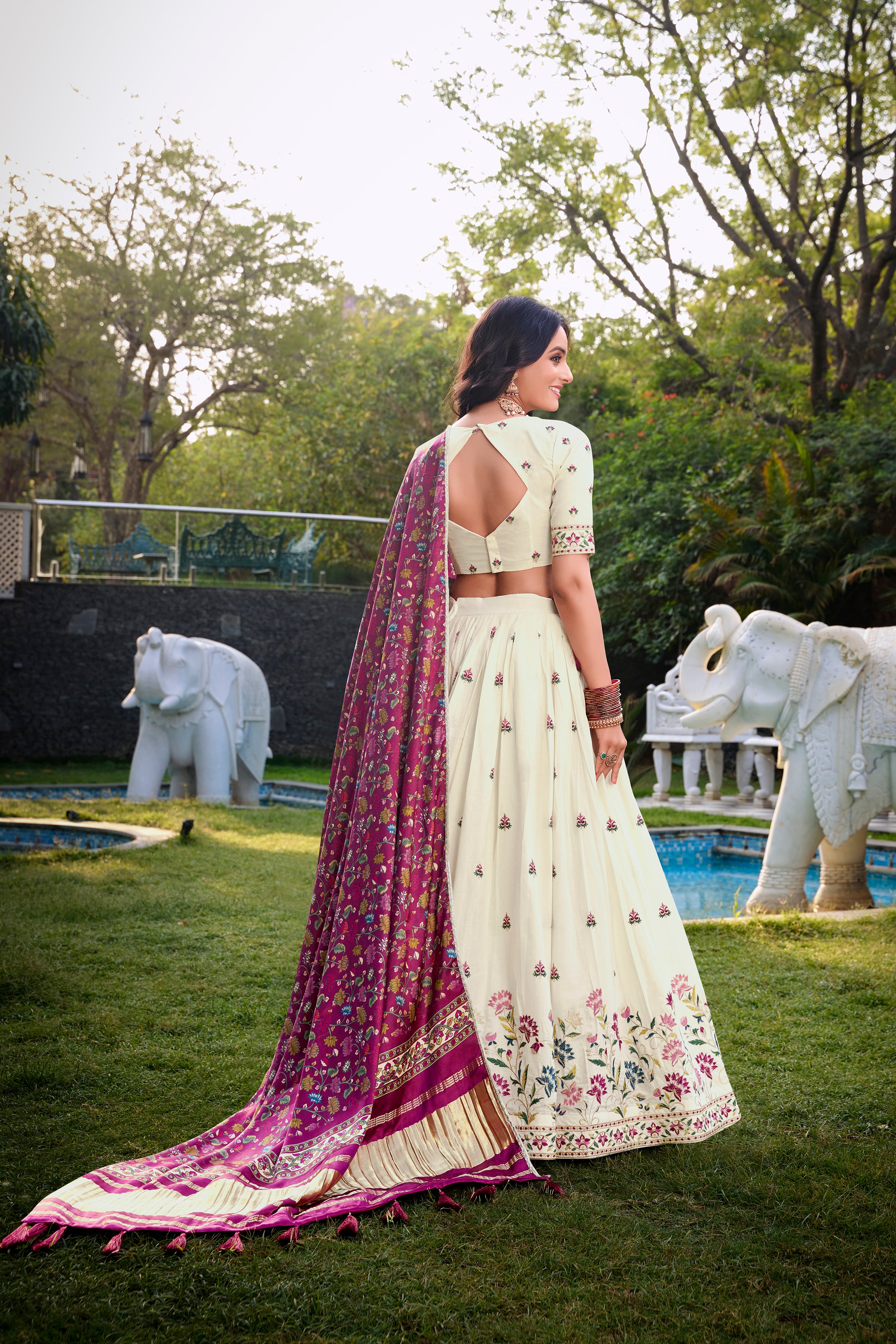 A vision of grace in an ivory lehenga adorned with peacock motifs.