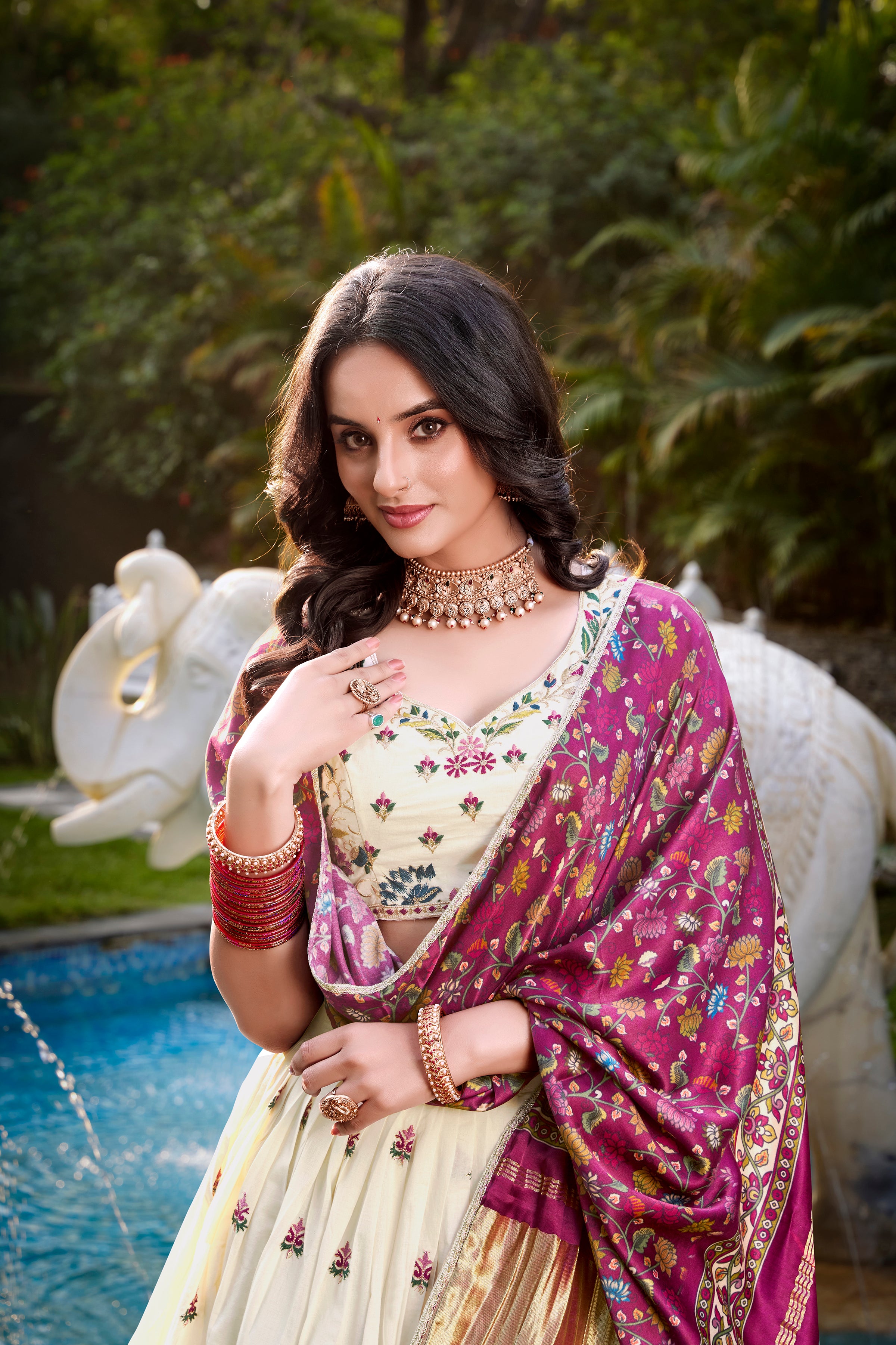 A vision of grace in an ivory lehenga adorned with peacock motifs.