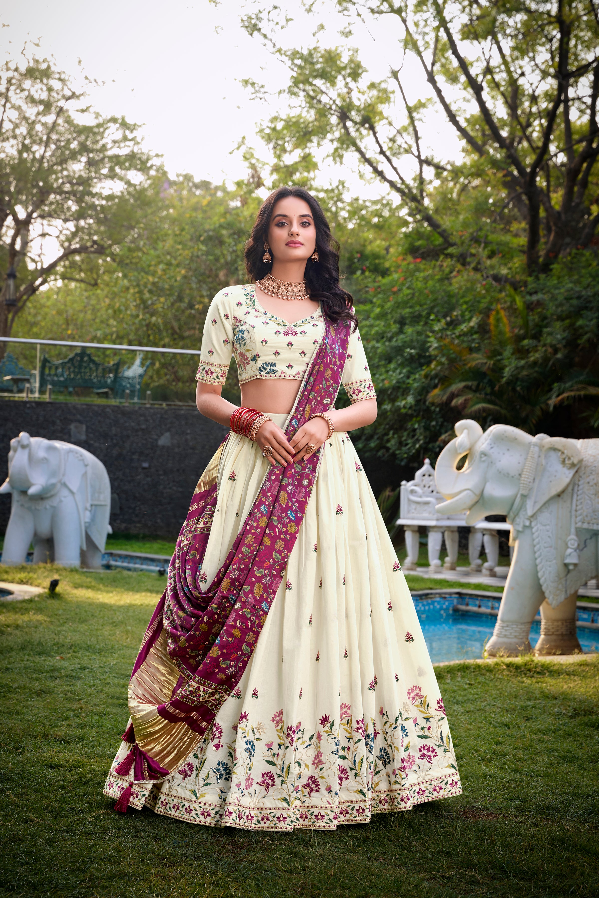 A vision of grace in an ivory lehenga adorned with peacock motifs.