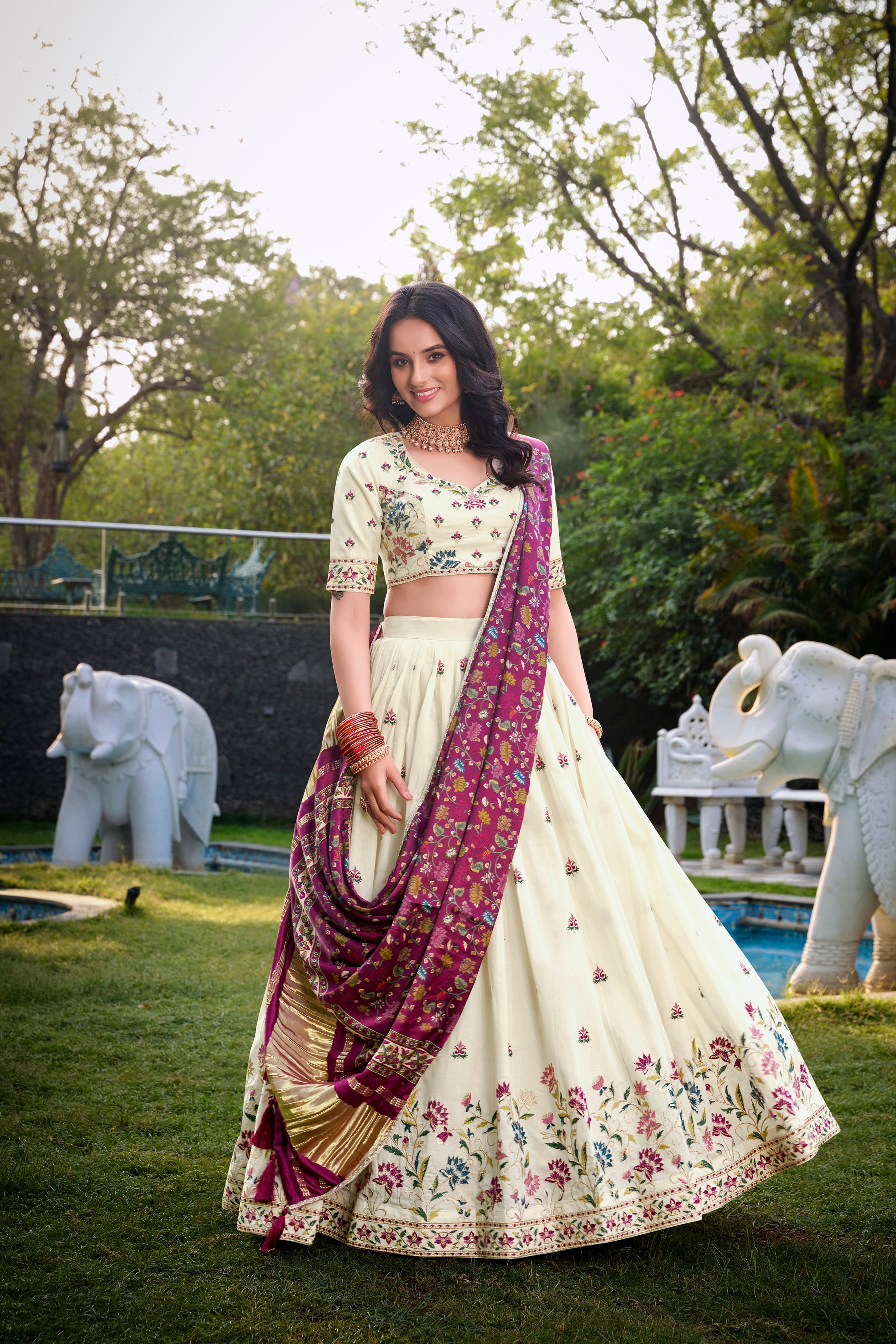 A vision of grace in an ivory lehenga adorned with peacock motifs.