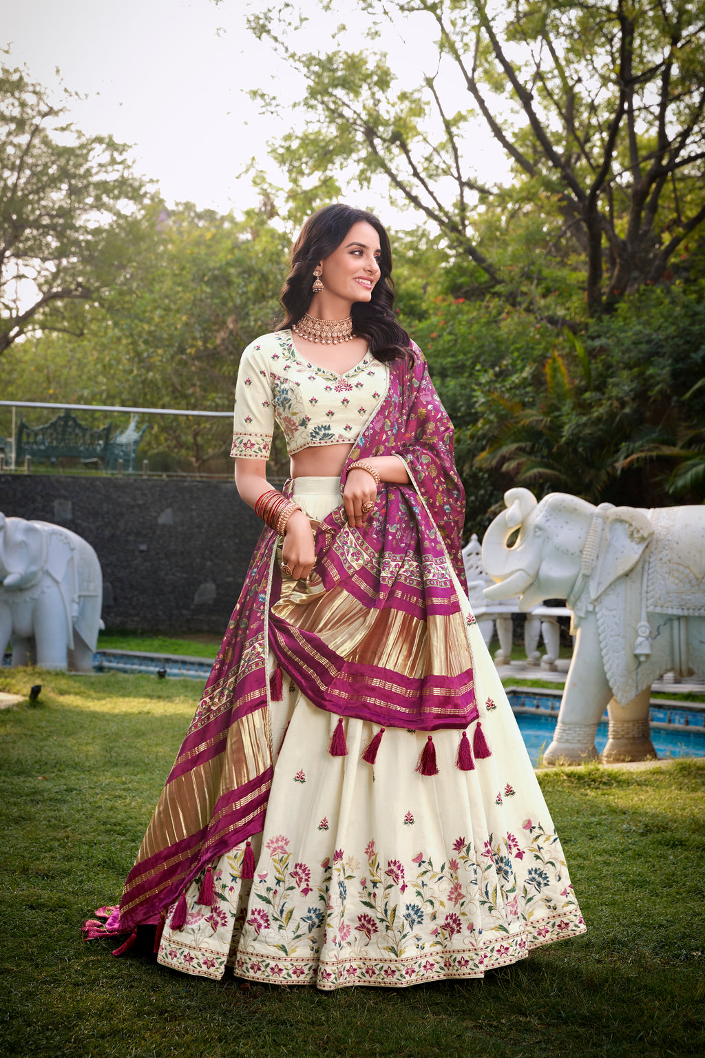 A vision of grace in an ivory lehenga adorned with peacock motifs.