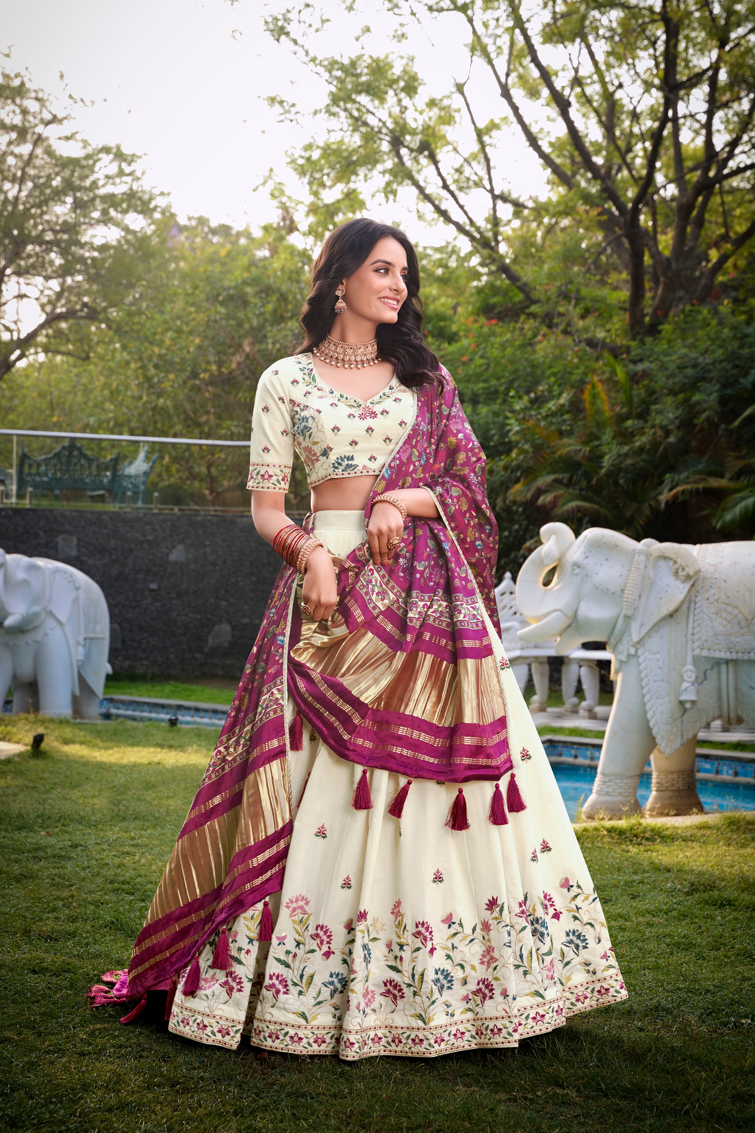 A vision of grace in an ivory lehenga adorned with peacock motifs.