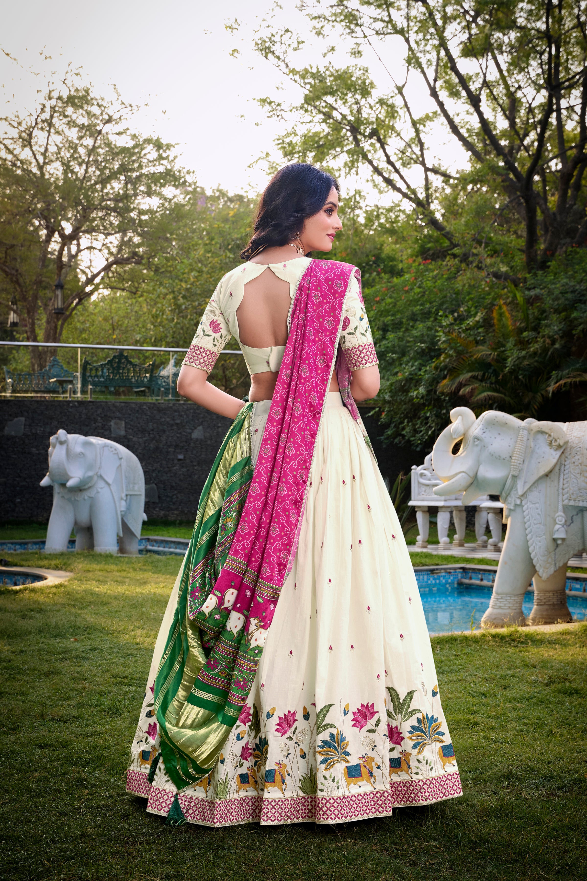 A vision of grace in an ivory lehenga adorned with peacock motifs.