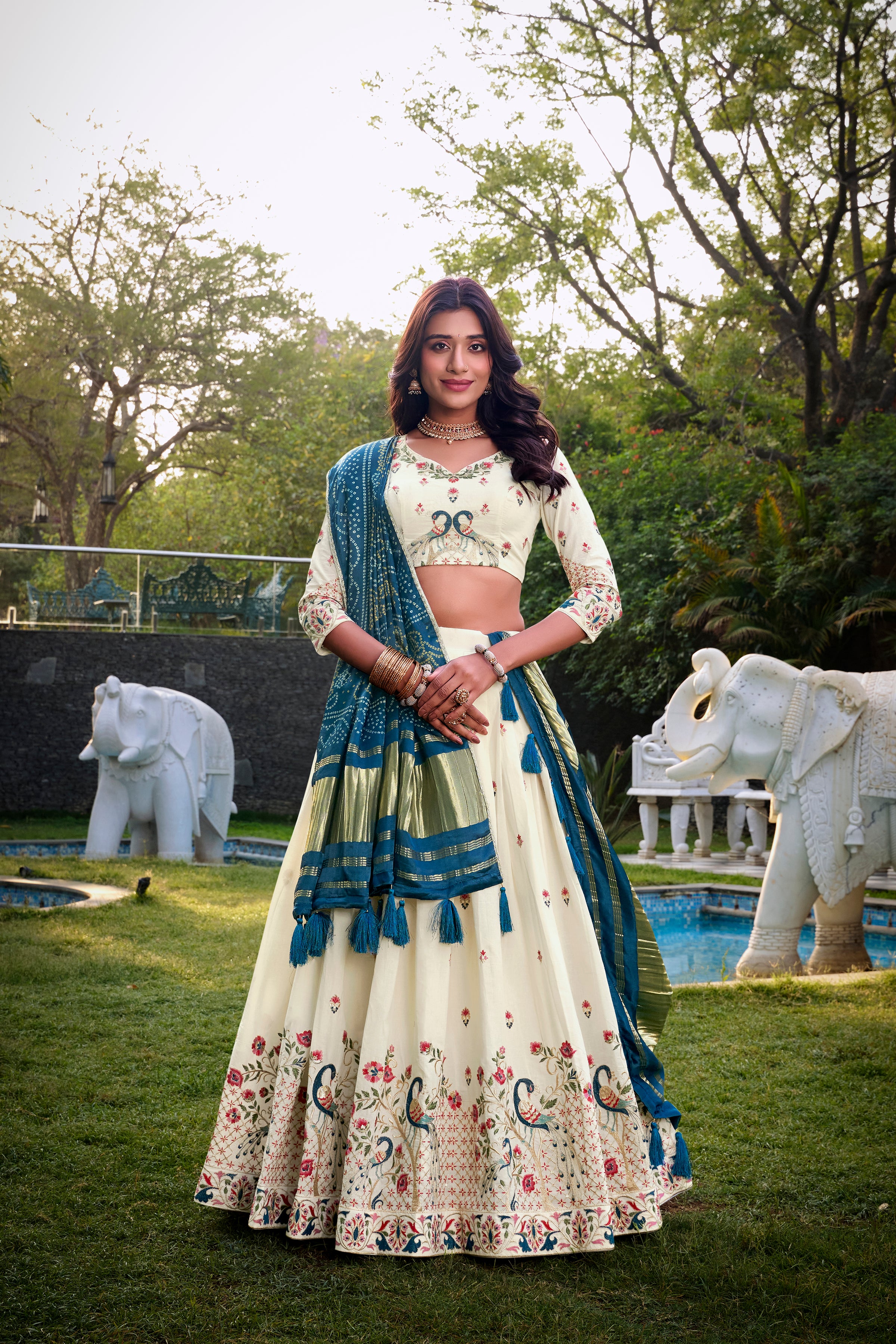 A vision of grace in an ivory lehenga adorned with peacock motifs.