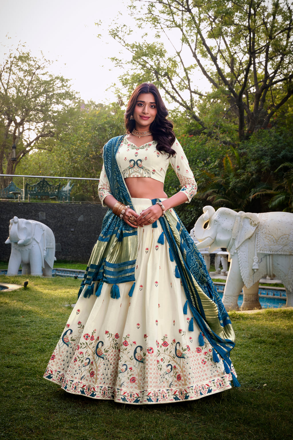 A vision of grace in an ivory lehenga adorned with peacock motifs.