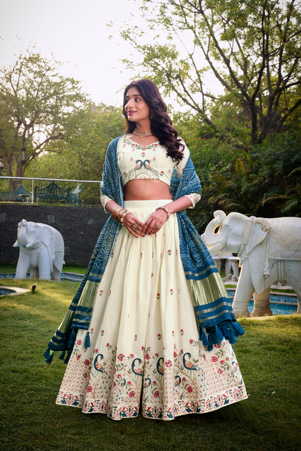 A vision of grace in an ivory lehenga adorned with peacock motifs.