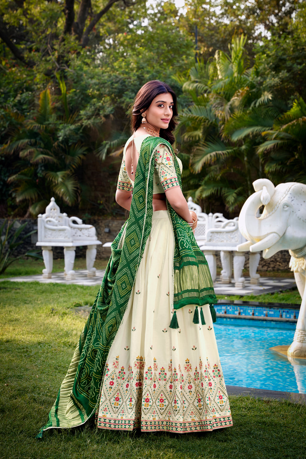 A vision of grace in an ivory lehenga adorned with peacock motifs.