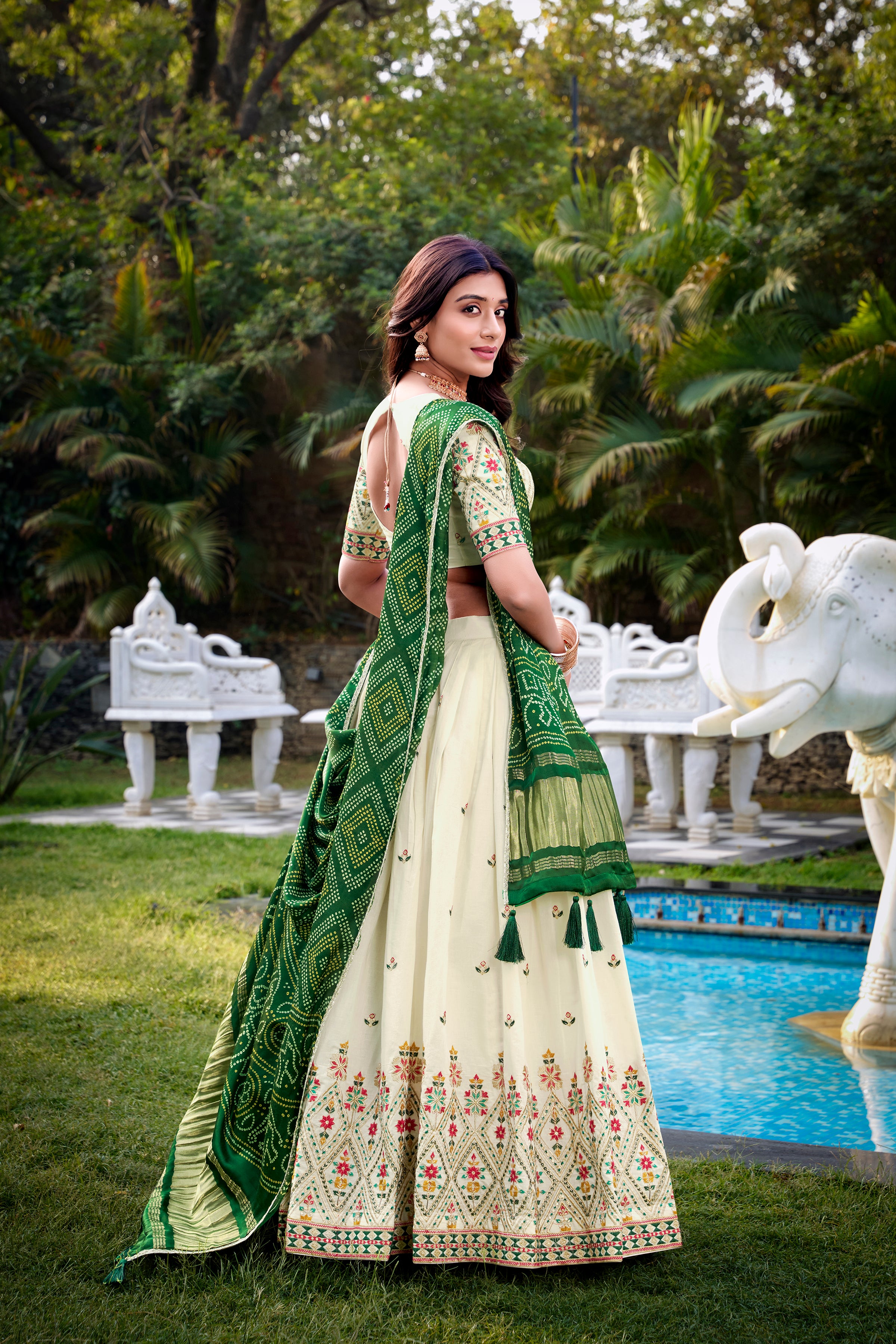 A vision of grace in an ivory lehenga adorned with peacock motifs.