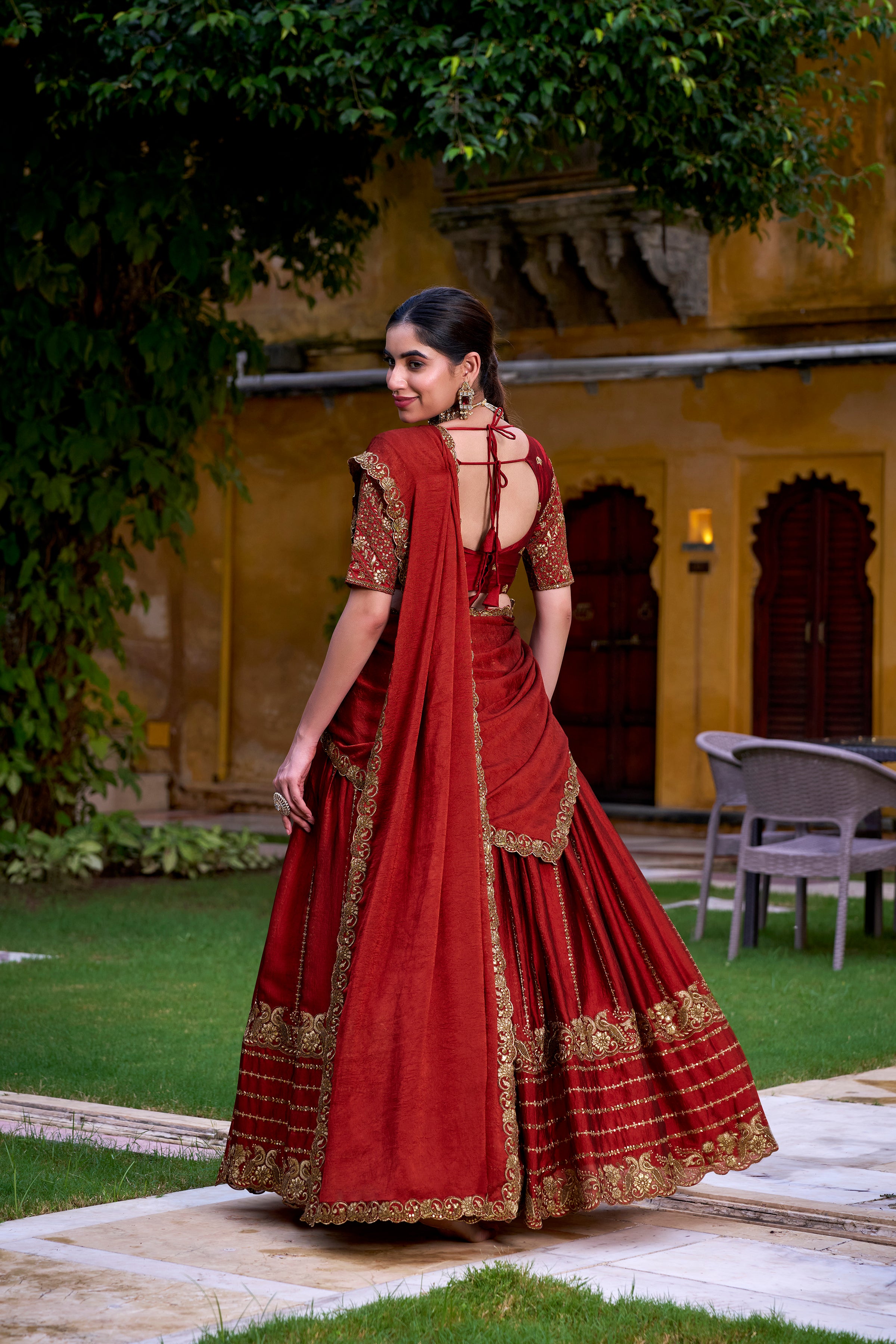 A captivating vision in a deep crimson and gold lehenga.