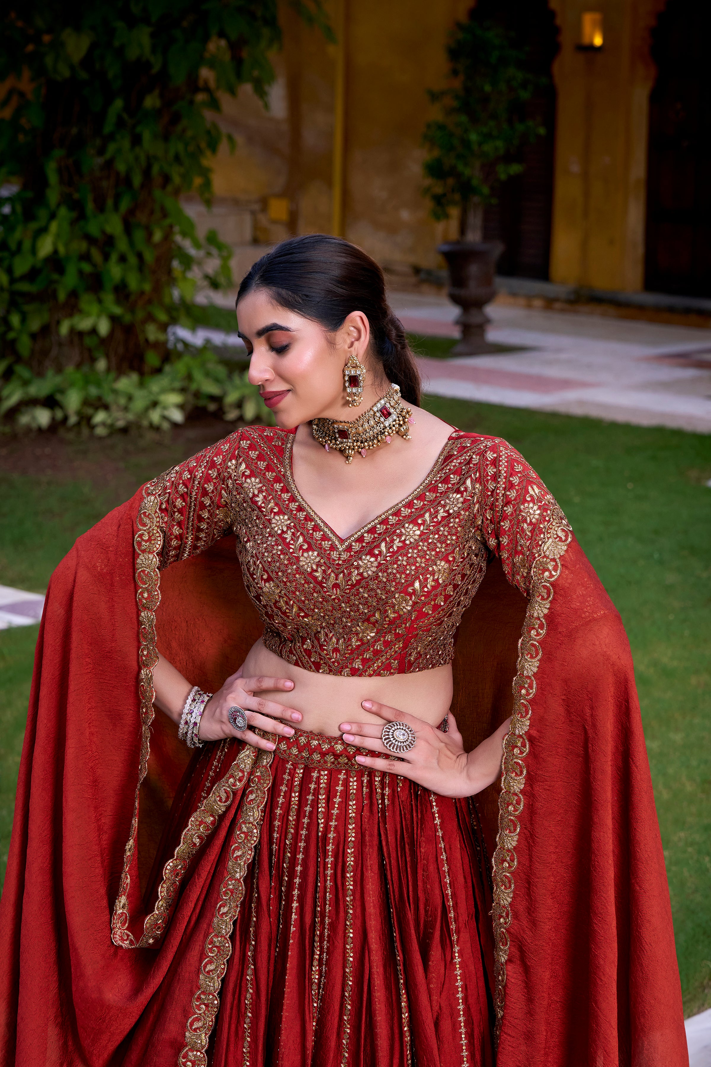 A captivating vision in a deep crimson and gold lehenga.