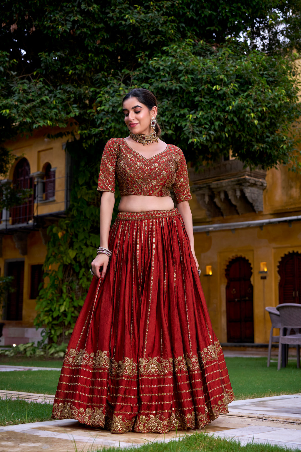 A captivating vision in a deep crimson and gold lehenga.