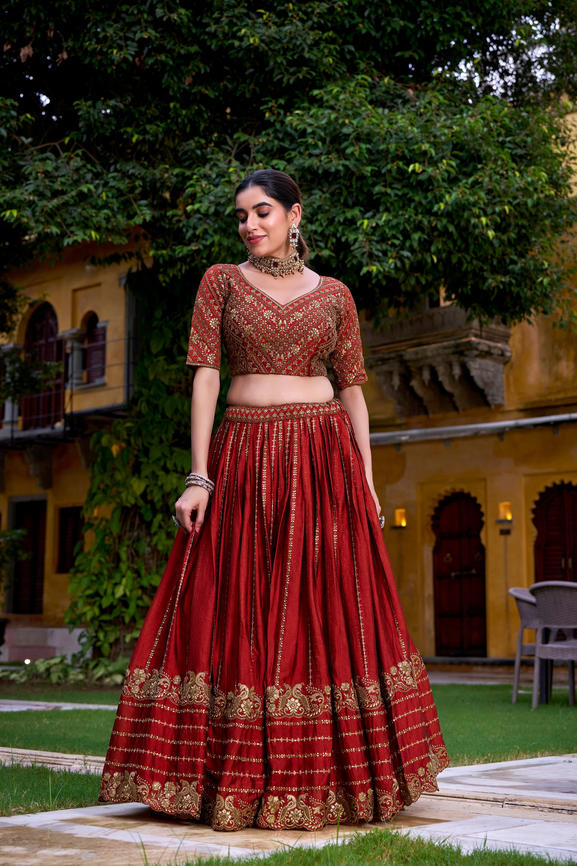 A captivating vision in a deep crimson and gold lehenga.