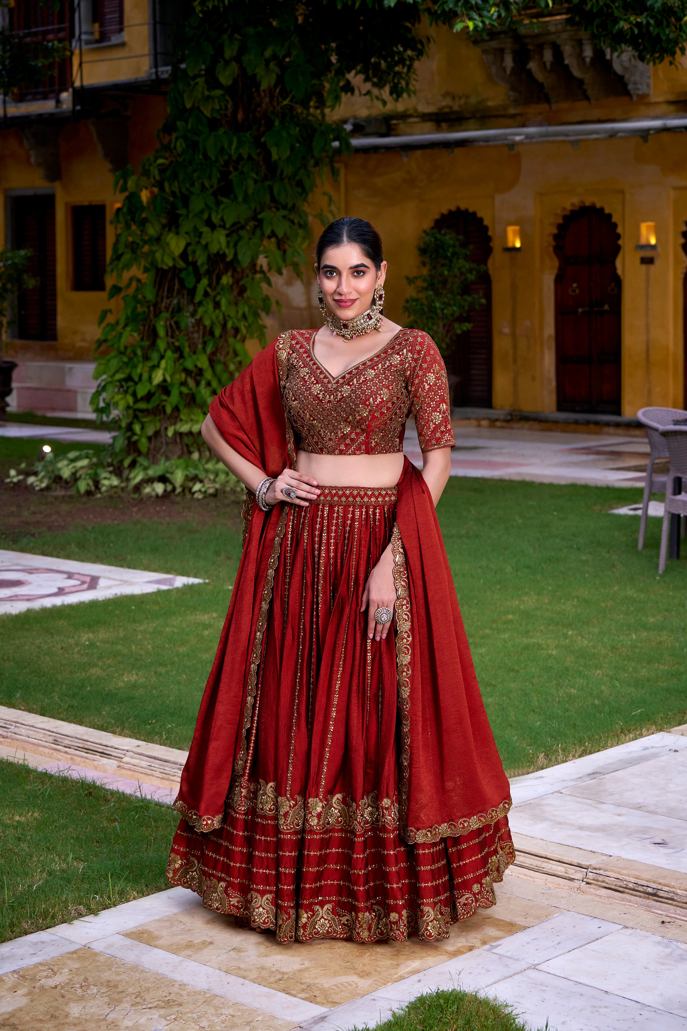 A captivating vision in a deep crimson and gold lehenga.