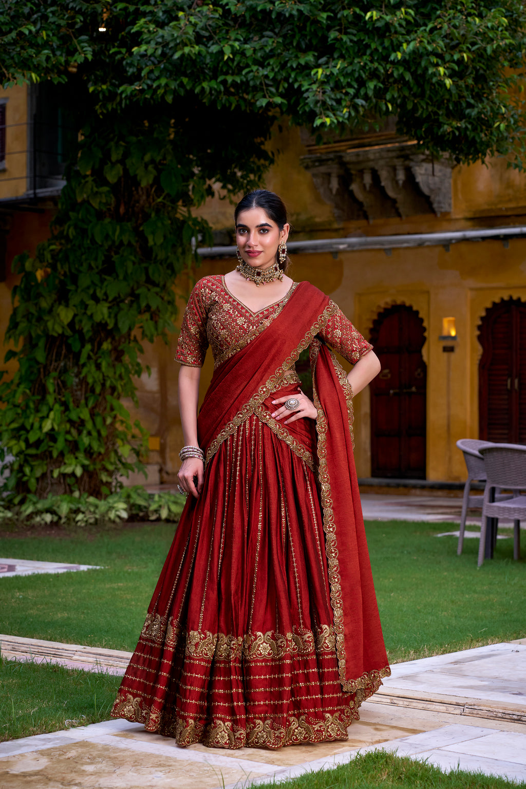 A captivating vision in a deep crimson and gold lehenga.