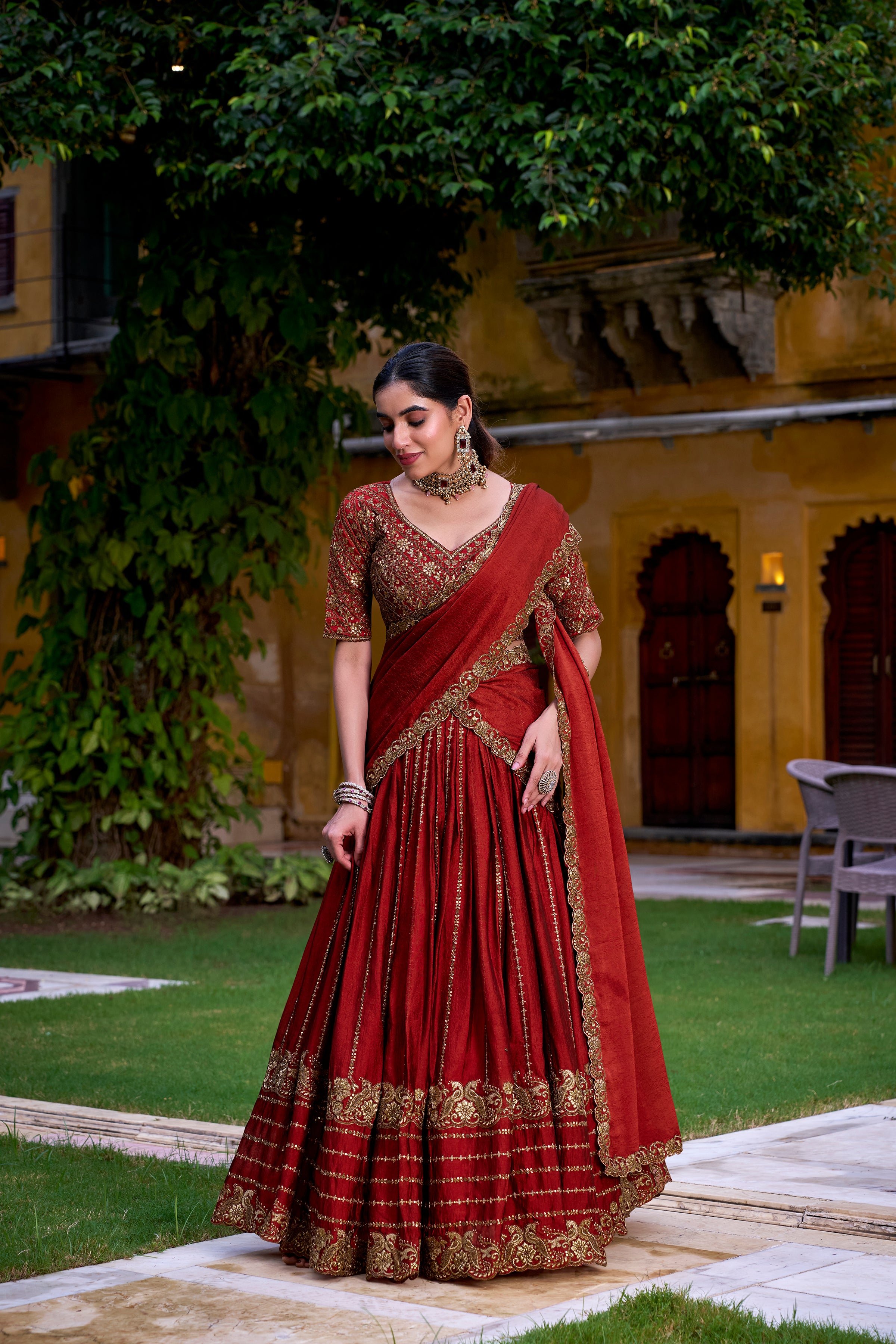 A captivating vision in a deep crimson and gold lehenga.