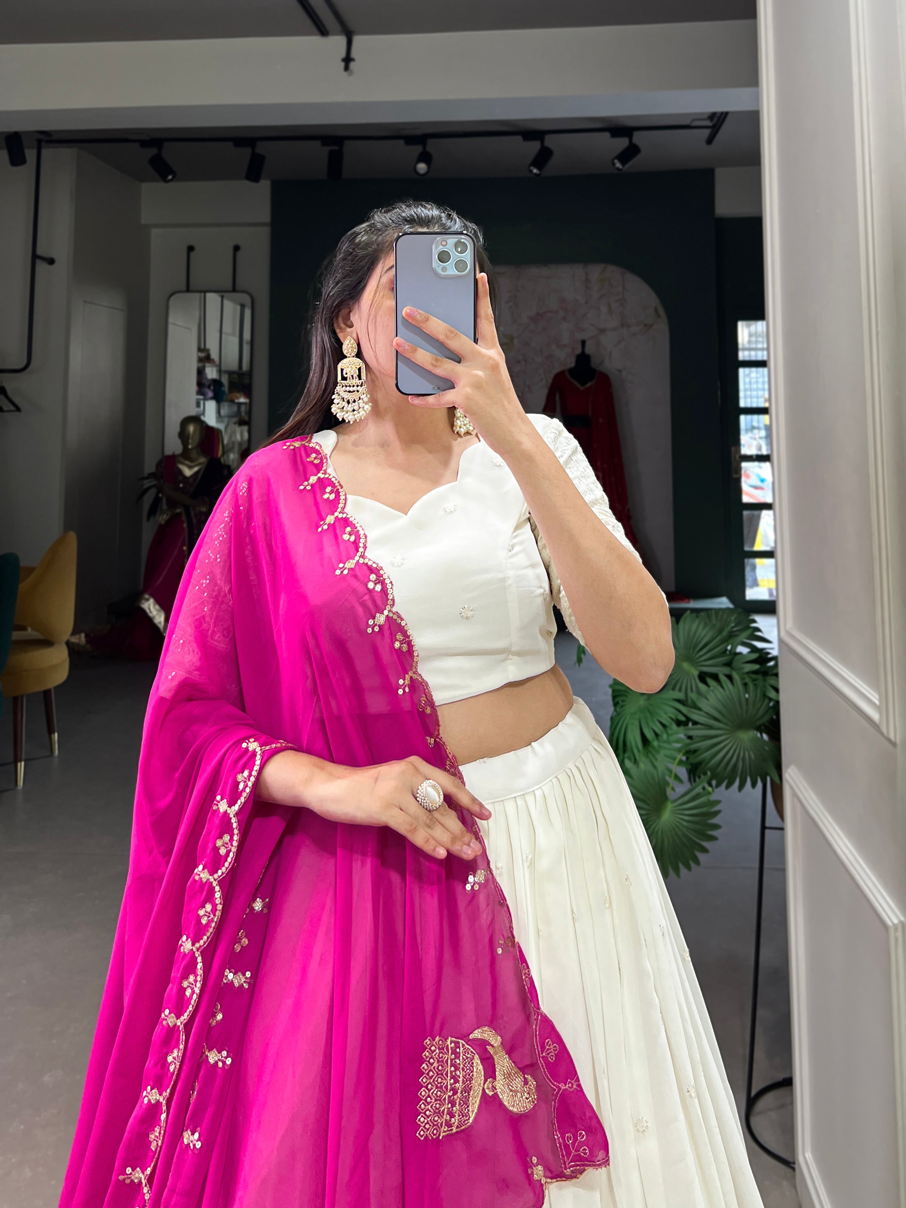 An elegant white lehenga made regal with a vibrant purple dupatta.