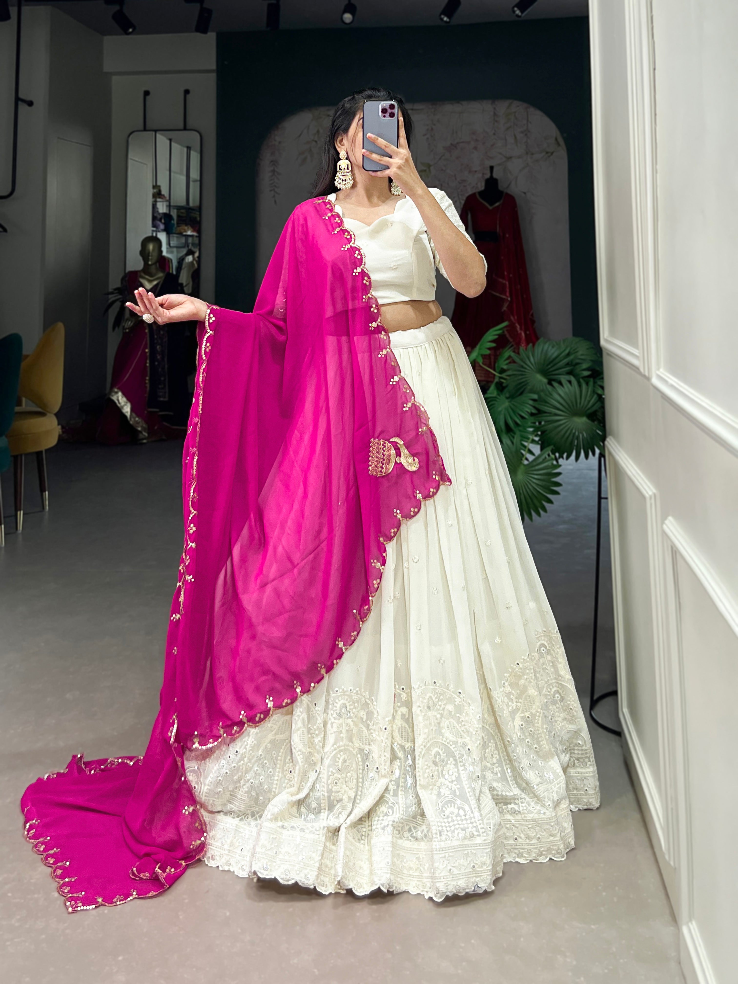 An elegant white lehenga made regal with a vibrant purple dupatta.