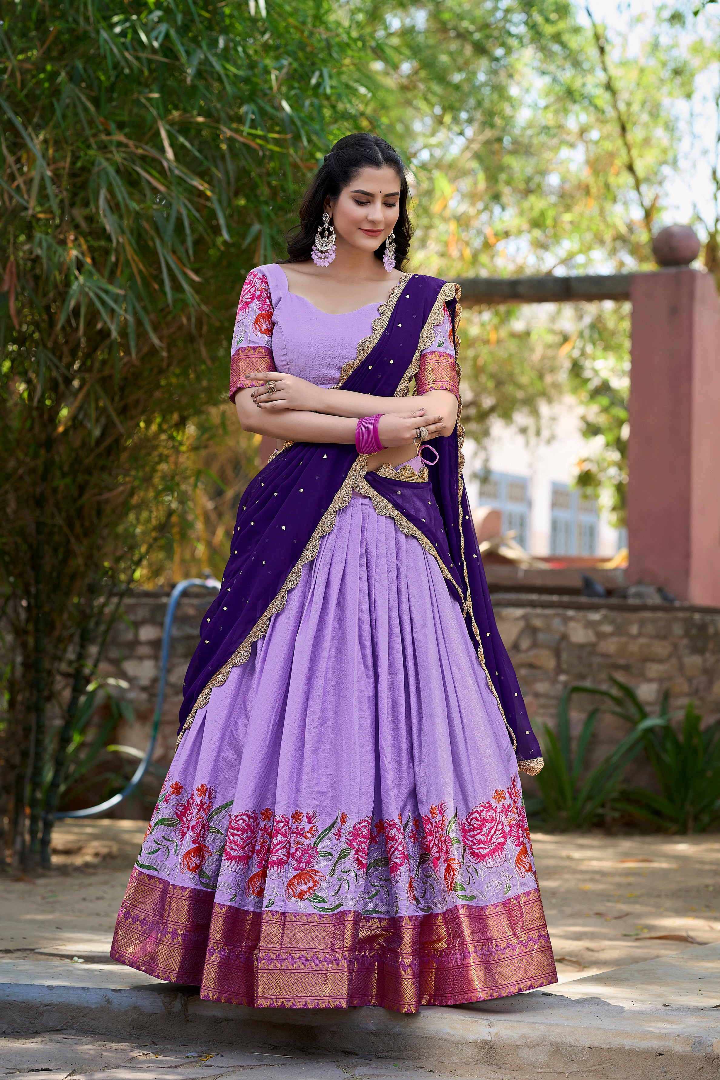 A vision of traditional grace in a floral lavender and purple lehenga.