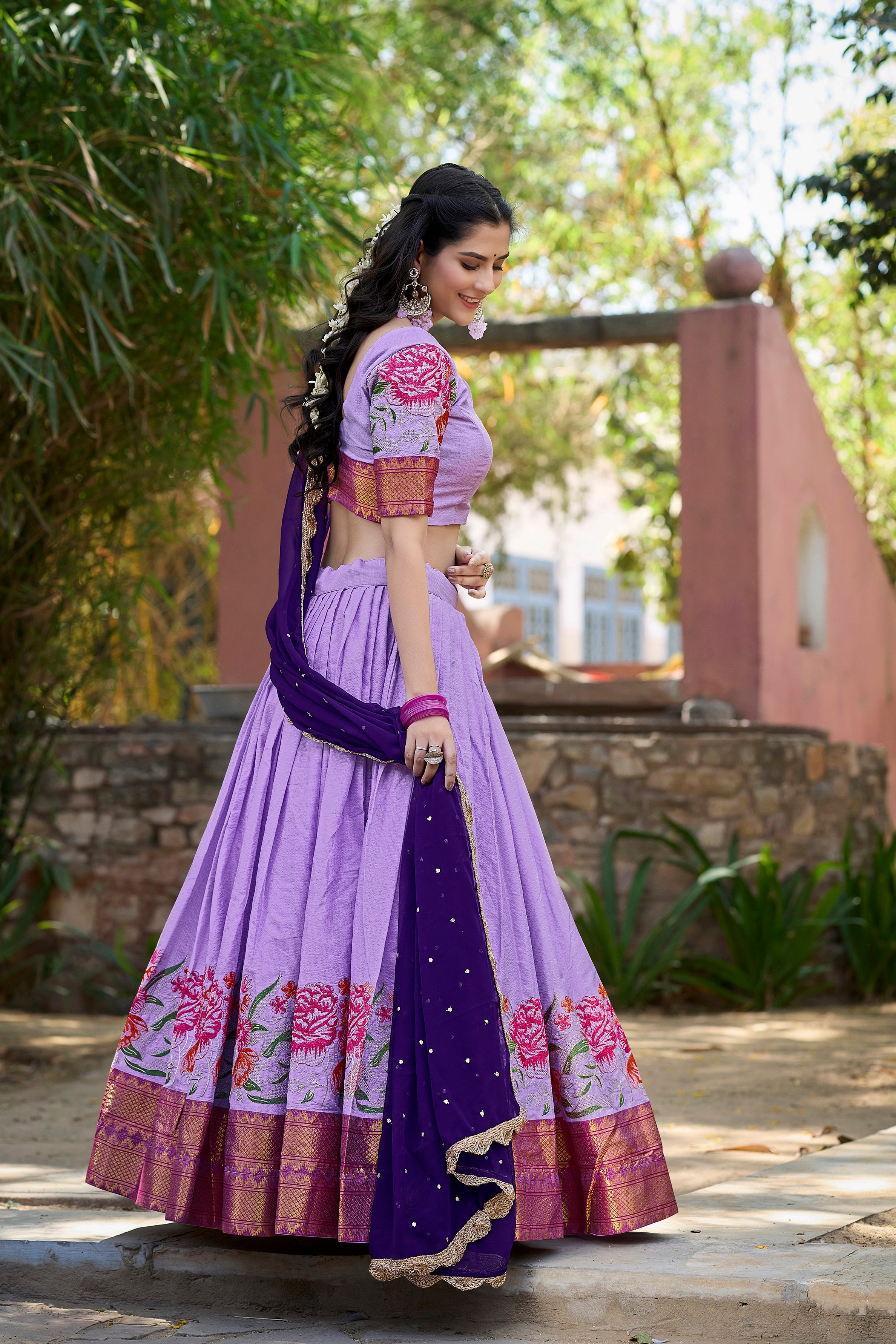 A vision of traditional grace in a floral lavender and purple lehenga.